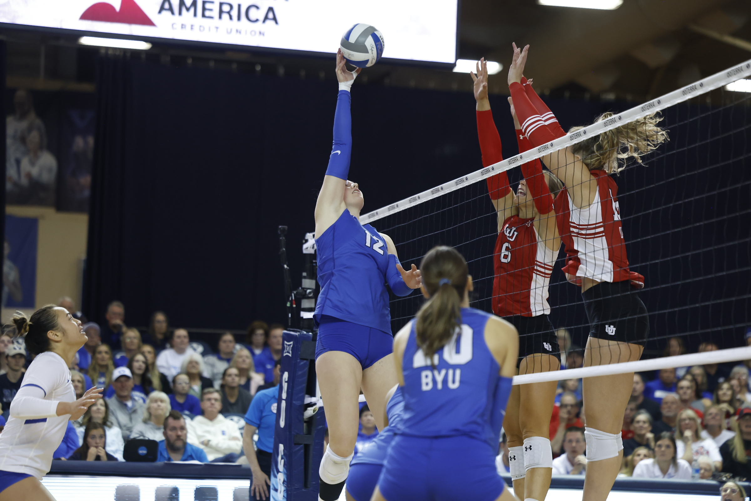 BYU outside hitter Claire Little tries to tool a kill against the Utah block, Saturday, Oct. 19, 2024, during a Big 12 women's volleyball match in the Smith Fieldhouse in Provo, Utah.