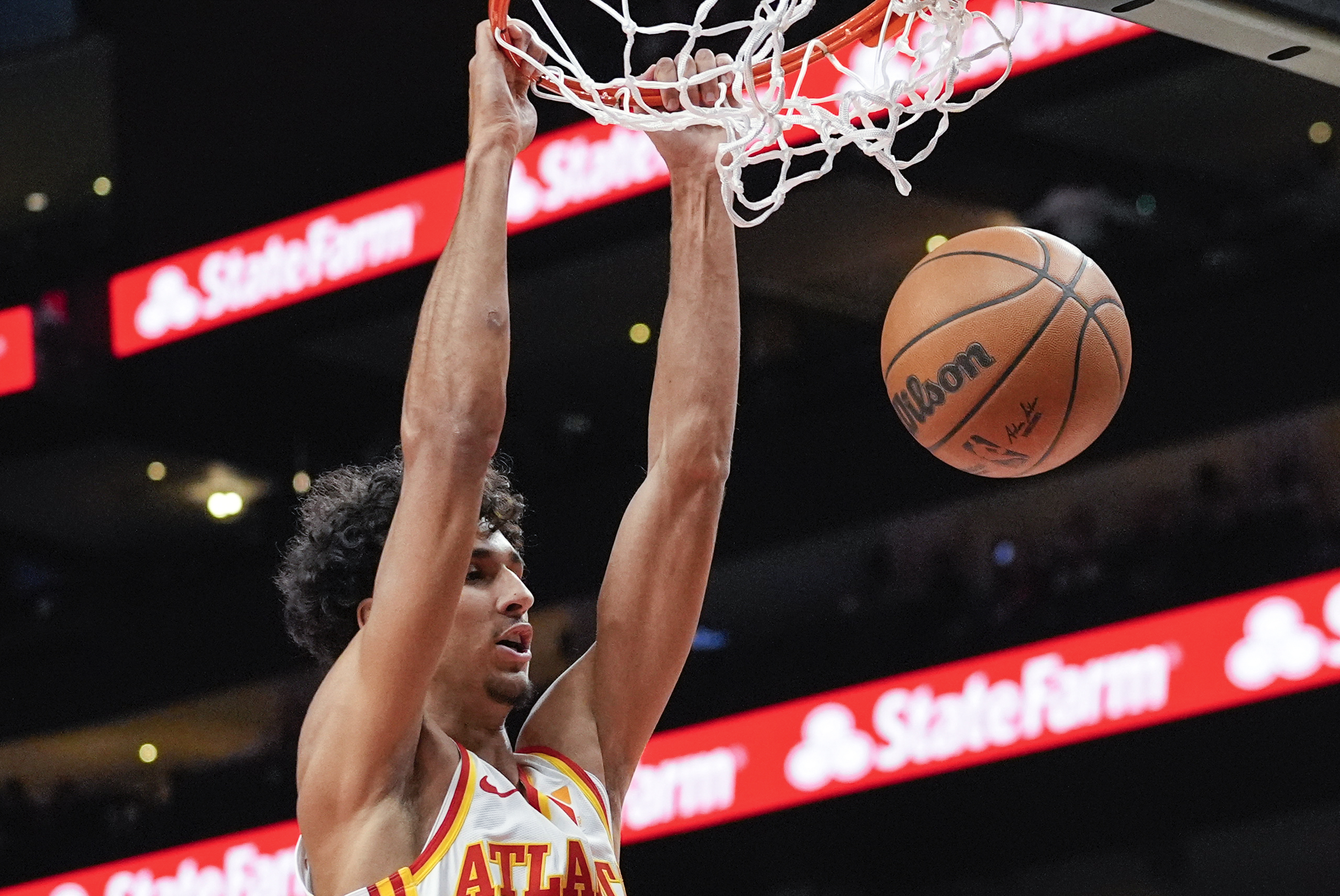 Atlanta Hawks forward Zaccharie Risacher (10) scores in the first half of a preseason NBA basketball game against the Philadelphia 76ers Monday, Oct. 14, 2024, in Atlanta.