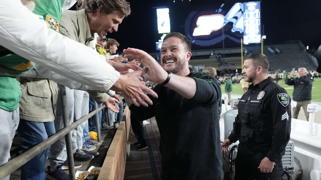 Oregon head coach Dan Lanning celebrates with fans after his team defeated Purdue in an NCAA college football game in West Lafayette, Ind., Friday, Oct. 18, 2024.