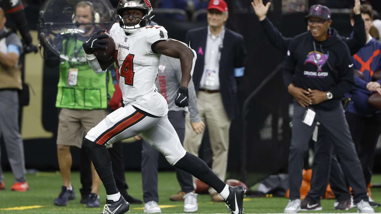 Tampa Bay Buccaneers wide receiver Chris Godwin runs toward the end zone to score against the New Orleans Saints during the second half of an NFL football game in New Orleans, Sunday, Oct. 13, 2024.