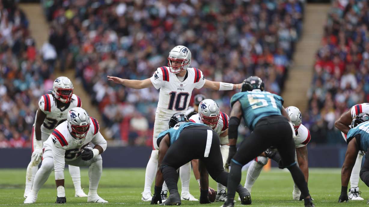 New England Patriots quarterback Drake Maye (10) calls an audible during the first half of an NFL football game against the Jacksonville Jaguars, Sunday, Oct. 20, 2024, in London.