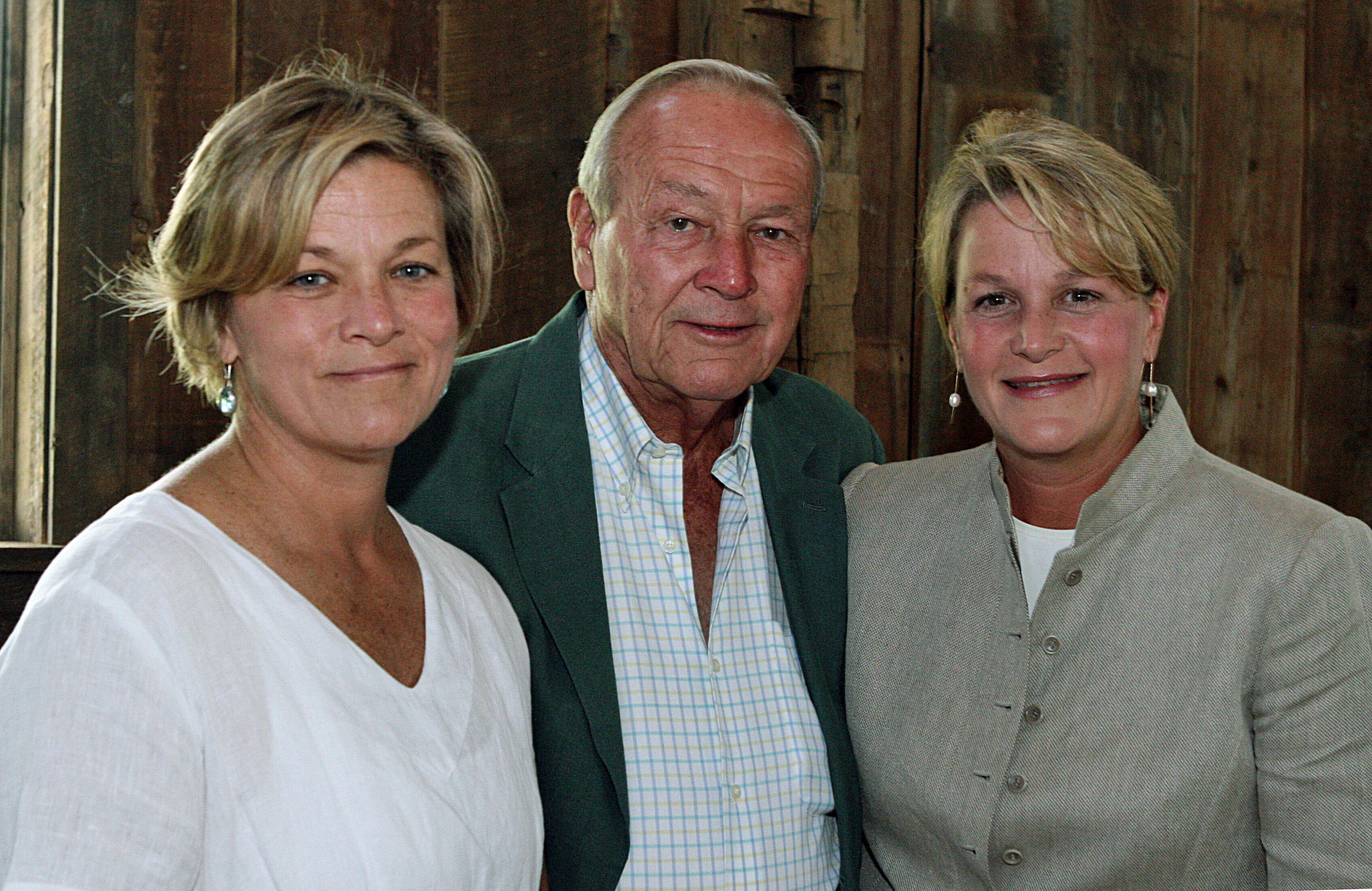 FILE - Arnold Palmer, center, is seen with his daughters, Peggy Palmer, left, of Durham, N.C., and Amy Saunders, of Orlando, Fla., inside the barn of the Winnie Palmer Nature Reserve, in Latrobe, Pa., during the dedication of the reserve June, 30, 2007. 