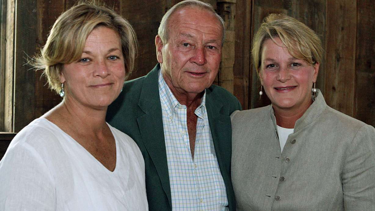 FILE - Arnold Palmer, center, is seen with his daughters, Peggy Palmer, left, of Durham, N.C., and Amy Saunders, of Orlando, Fla., inside the barn of the Winnie Palmer Nature Reserve, in Latrobe, Pa., during the dedication of the reserve June, 30, 2007.