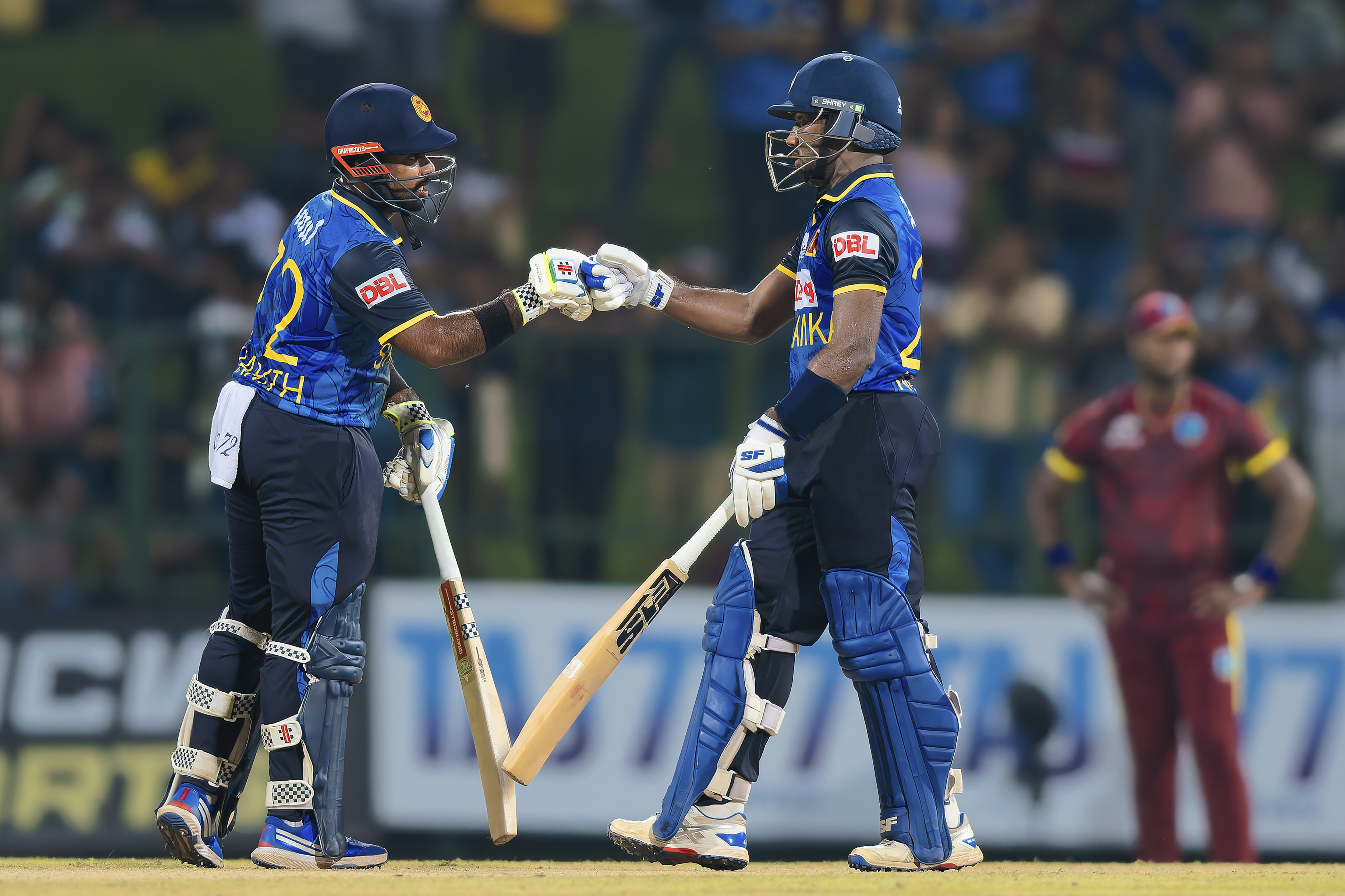 Sri Lanka's Captain Charith Asalanka, left, and Nishan Madushka, bump fists during the first ODI cricket match between Sri Lanka and West Indies in Pallekele, Sri Lanka, Sunday, Oct. 20, 2024. 