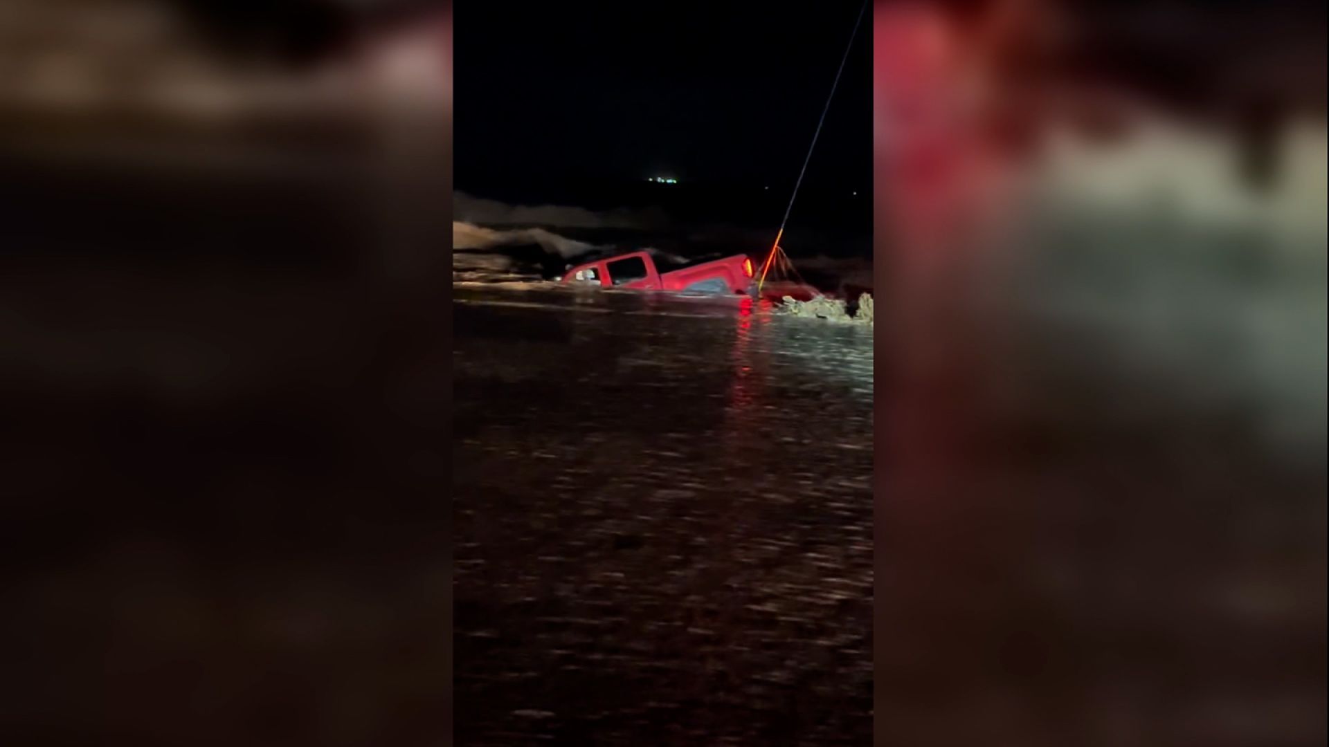 A truck is seen submerged in flood waters in Hagerman, New Mexico. At least two people have died and hundreds have been rescued in flooding in Roswell, New Mexico, according to police.