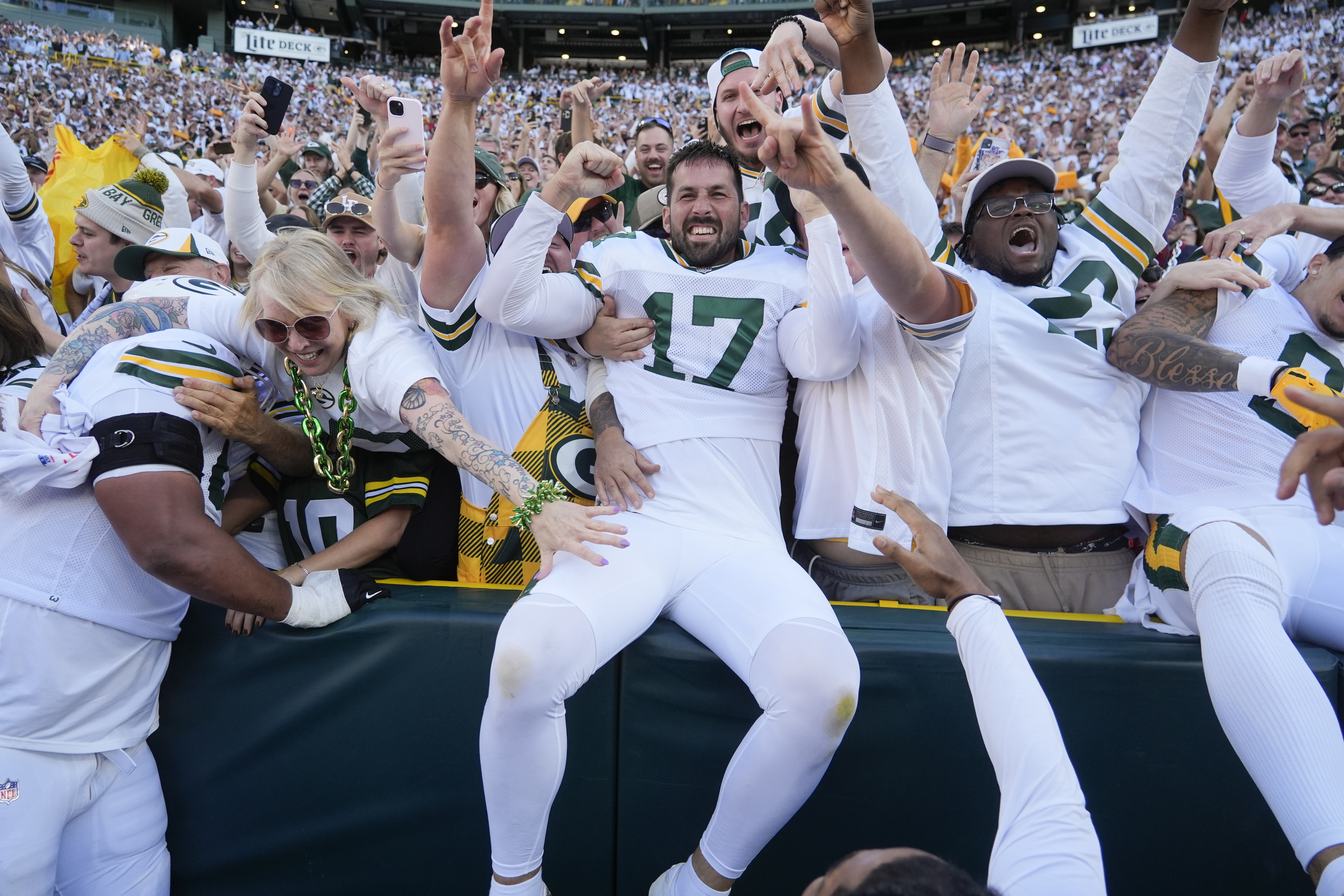Green Bay Packers place kicker Brandon McManus (17) celebrates with fans after kicking the game-winning field goal in the second half of an NFL football game, Sunday, Oct. 20, 2024, in Green Bay, Wis. The Packers won 24-22. 