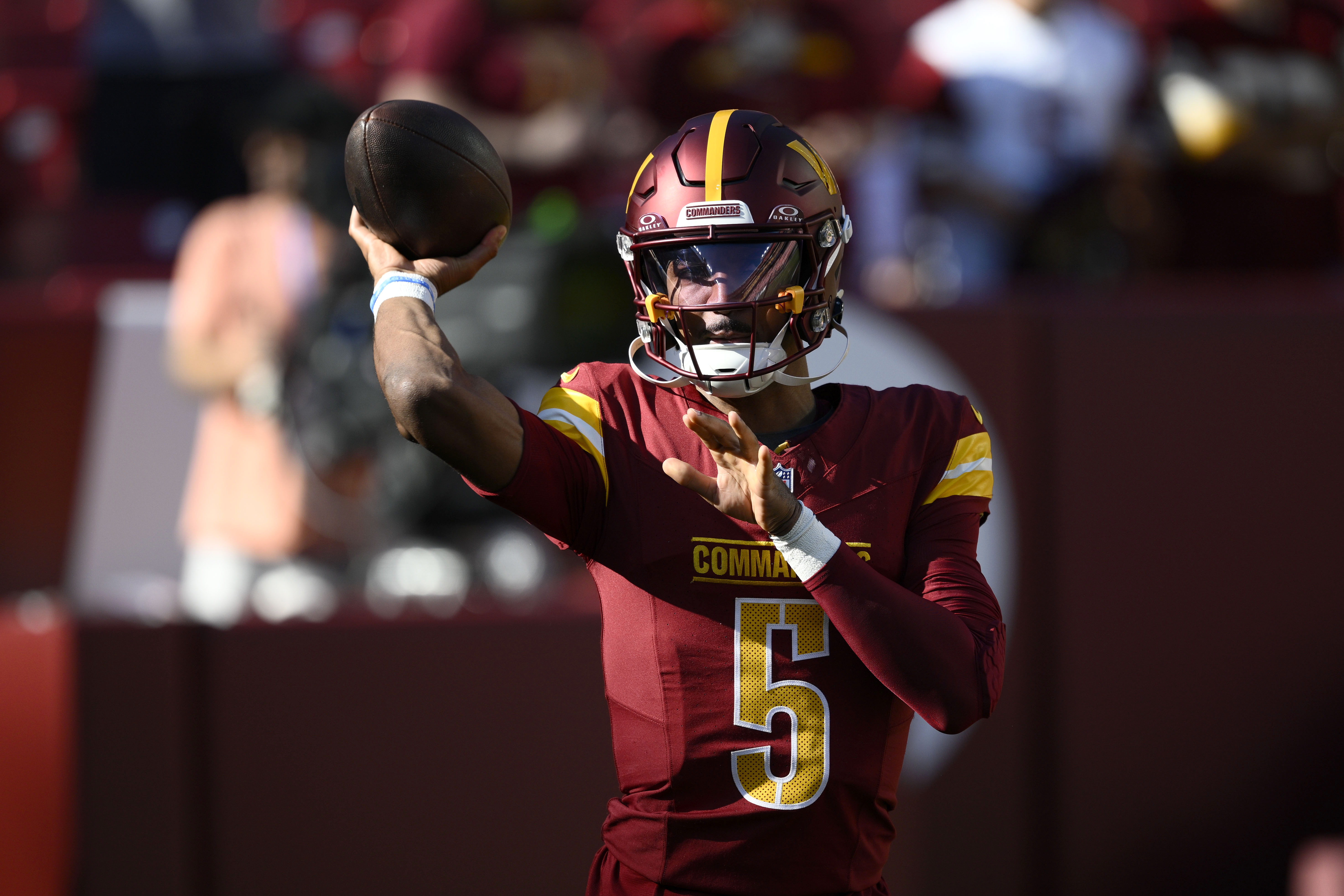 Washington Commanders quarterback Jayden Daniels warms up before an NFL football game against the Carolina Panthers, Sunday, Oct. 20, 2024, in Landover, Md. 
