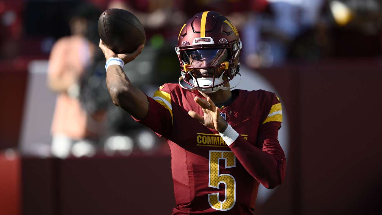 Washington Commanders quarterback Jayden Daniels warms up before an NFL football game against the Carolina Panthers, Sunday, Oct. 20, 2024, in Landover, Md.
