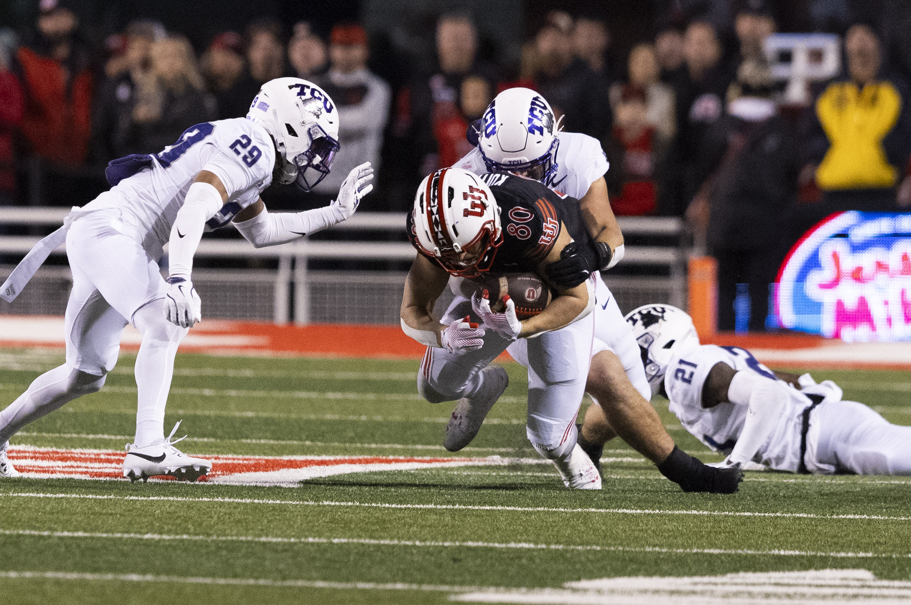 TCU Horned Frogs linebacker Johnny Hodges (57) tackles Utah Utes tight end Brant Kuithe (80) during a game between the University of Utah and the TCU Horned Frogs at Rice-Eccles Stadium in Salt Lake City on Saturday, Oct. 19, 2024. The TCU Horned Frogs defeated the Utah Utes 13-7.