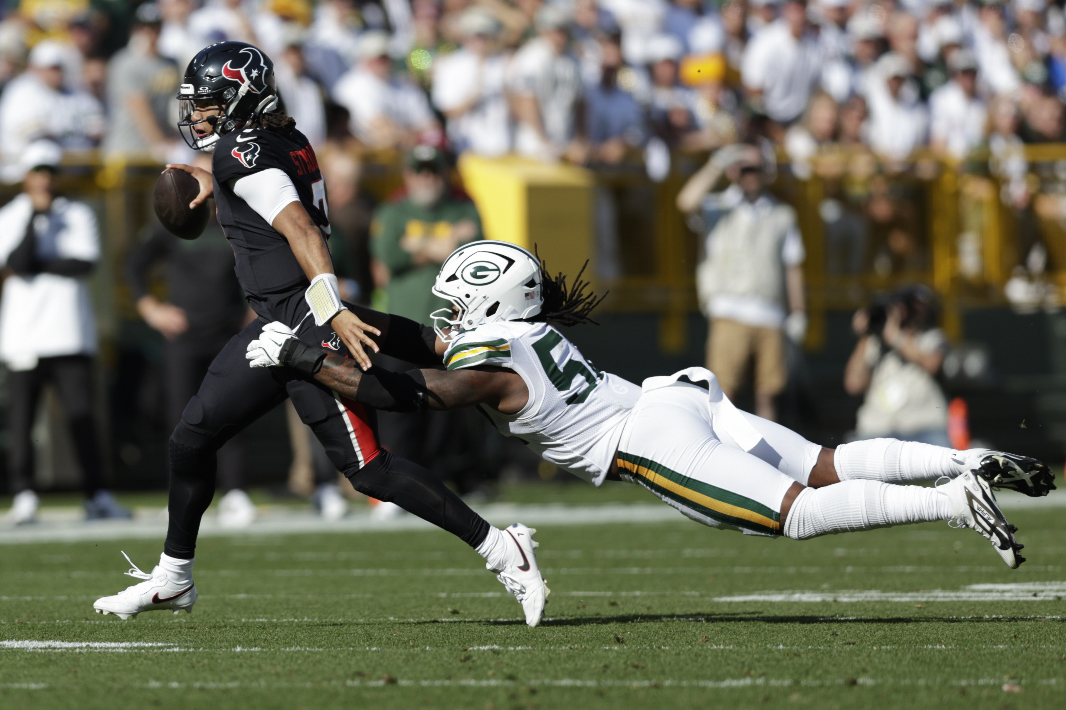 Houston Texans quarterback C.J. Stroud (7) tries to get past Green Bay Packers defensive end Rashan Gary (52) during the first half of an NFL football game, Sunday, Oct. 20, 2024, in Green Bay, Wis. 