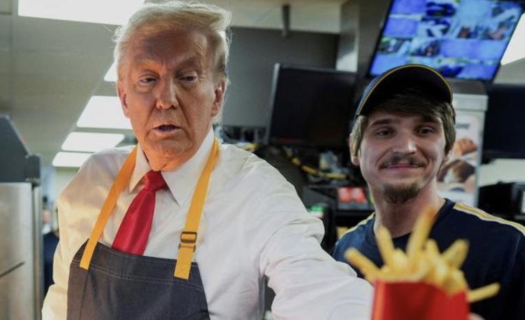 Republican presidential nominee and former President Donald Trump serves food at a McDonald's restaurant in Feasterville-Trevose, Pennsylvania, Sunday.