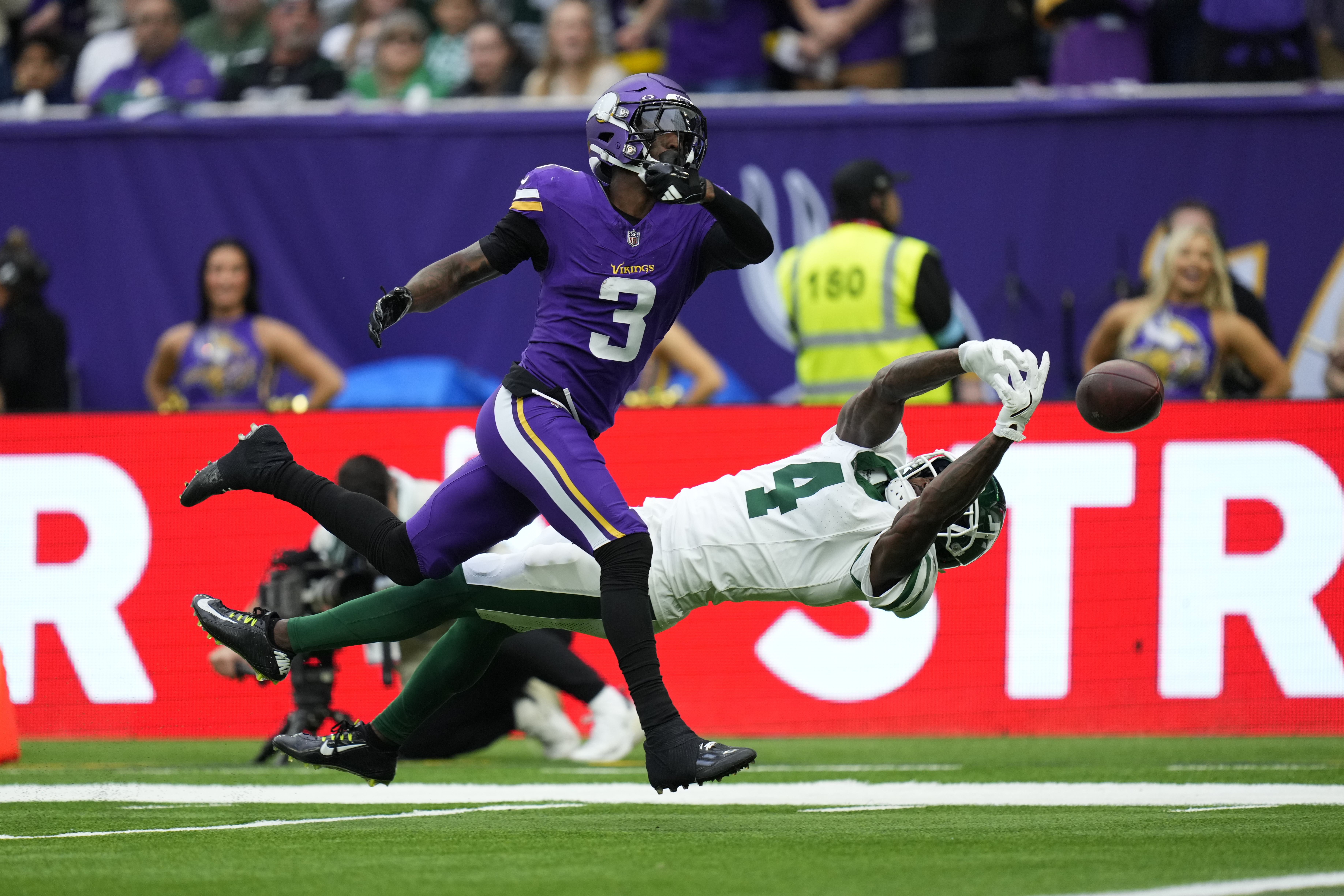 Minnesota Vikings' Jordan Addison (3), left, can't make the catch while New York Jets' D.J. Reed defends during the first half of an NFL football game, Sunday, Oct. 6, 2024, at the Tottenham Hotspur stadium in London. 