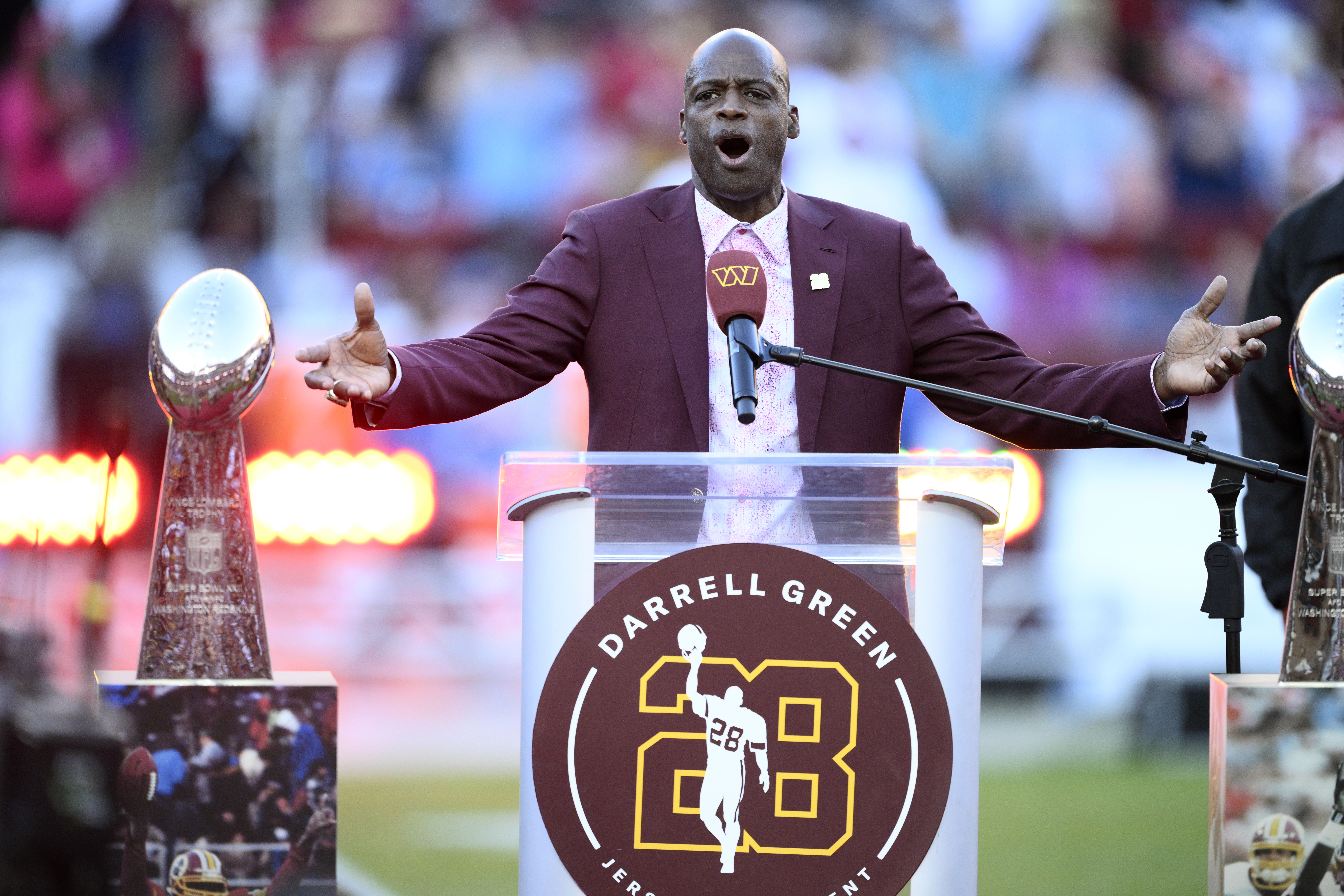 Former Washington defensive back Darrell Green speaks during a jersey retirement ceremony at halftime of an NFL football game between the Washington Commanders and the Carolina Panthers, Sunday, Oct. 20, 2024, in Landover, Md. 