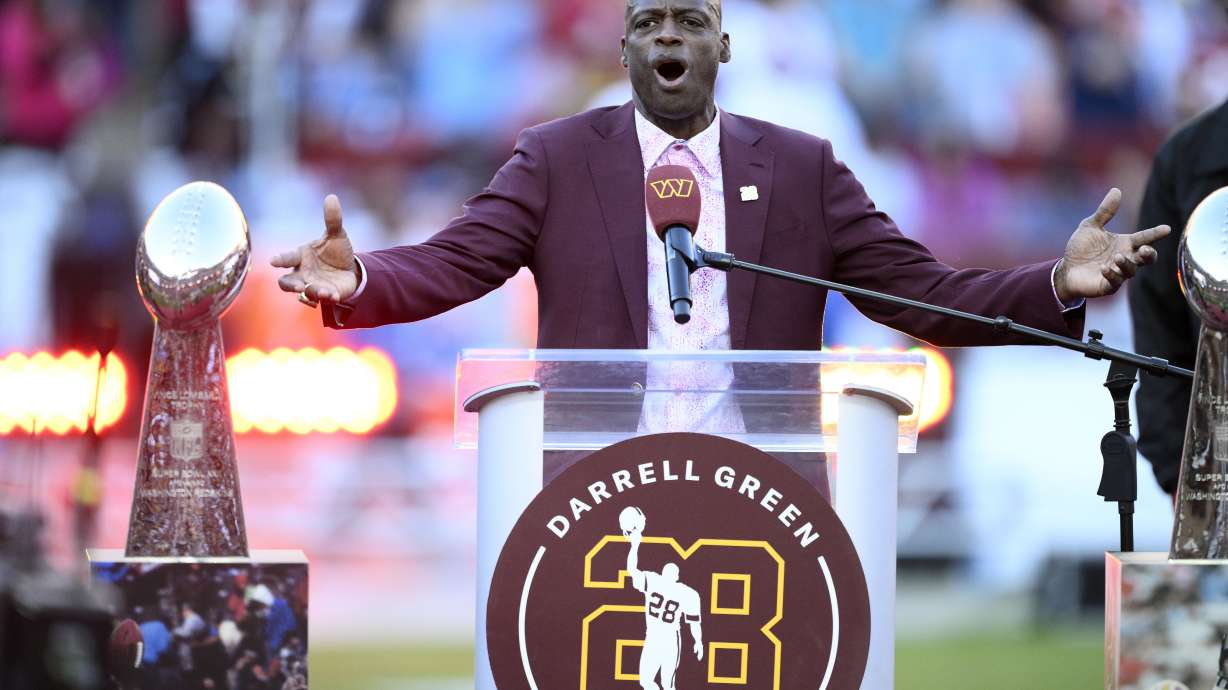 Former Washington defensive back Darrell Green speaks during a jersey retirement ceremony at halftime of an NFL football game between the Washington Commanders and the Carolina Panthers, Sunday, Oct. 20, 2024, in Landover, Md.