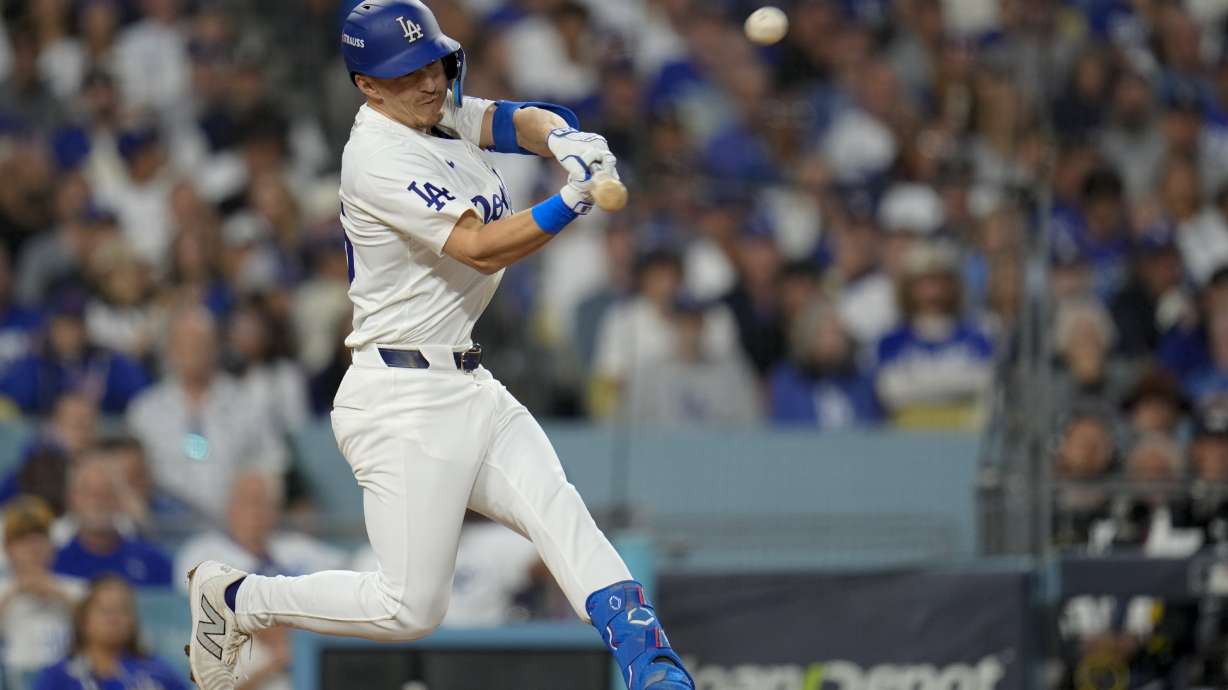 Los Angeles Dodgers' Tommy Edman hits a two-run home run against the New York Mets during the third inning in Game 6 of a baseball NL Championship Series, Sunday, Oct. 20, 2024, in Los Angeles.