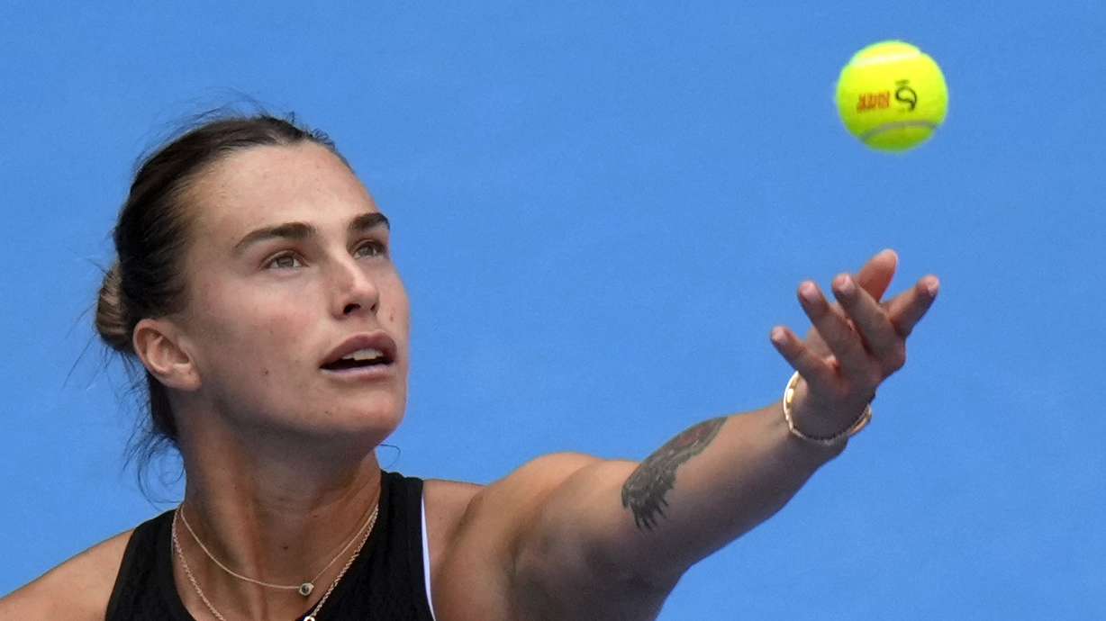 Aryna Sabalenka of Belarus tosses the ball to serve against Karolina Muchova of the Czech Republic during their women's singles quarterfinals match of the China Open tennis tournament, at the National Tennis Center in Beijing, Friday, Oct. 4, 2024.