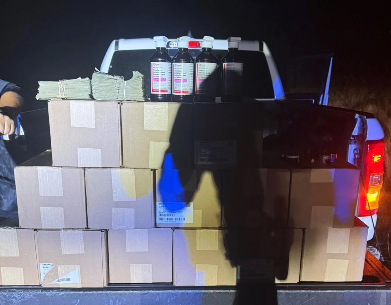 Cases of prescription cough syrup and cash recovered from a pickup truck during a traffic stop on I-15 in the city of Washington, Washington County, Thursday are shown.