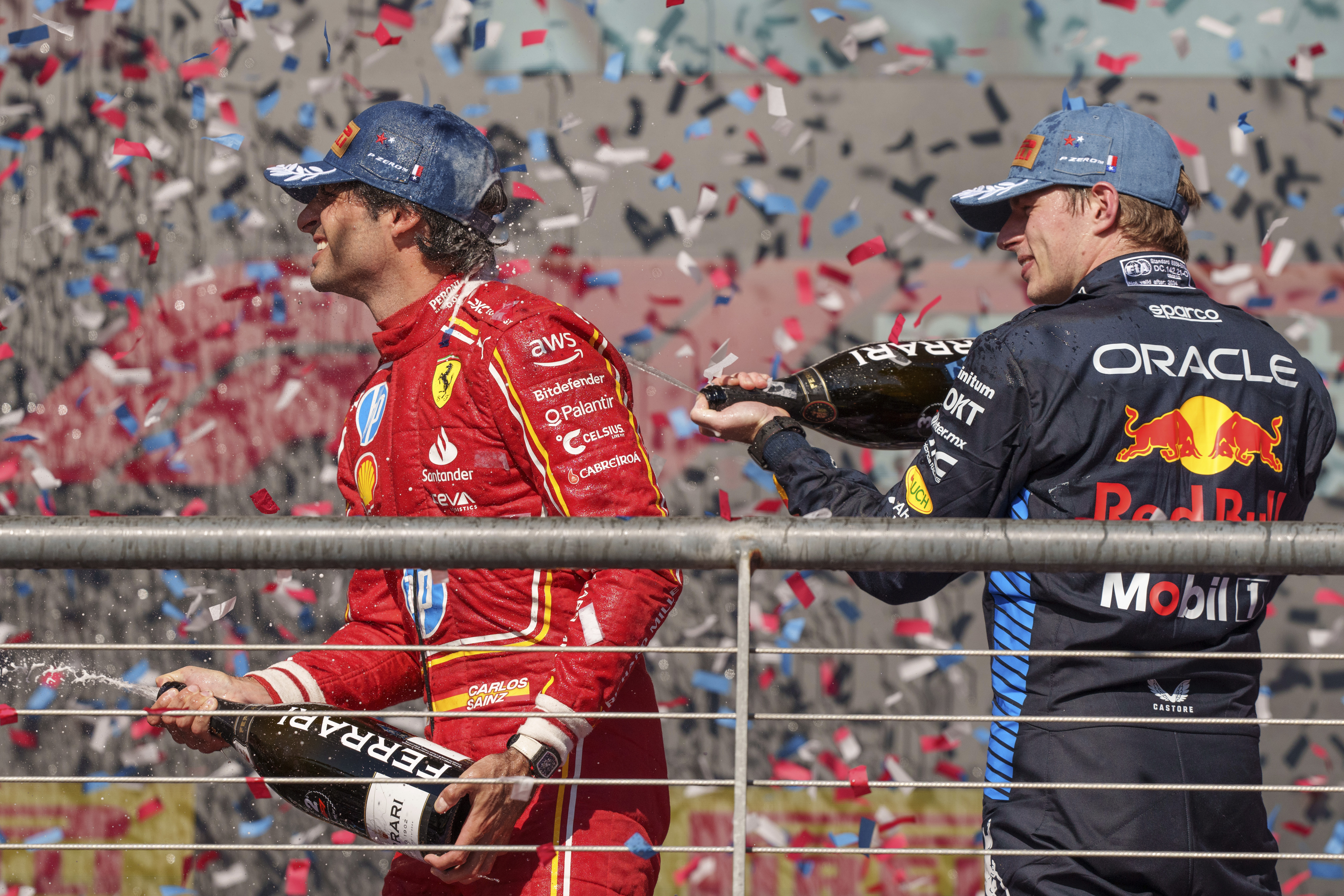 Ferrari driver Carlos Sainz, of Spain, left, and Red Bull driver Max Verstappen, right, of the Netherlands, celebrate after they finished second and third respectively behind winner Charles Leclerc in the Formula One U.S. Grand Prix auto race at Circuit of the Americas, Sunday, Oct. 20, 2024, in Austin, Texas.
