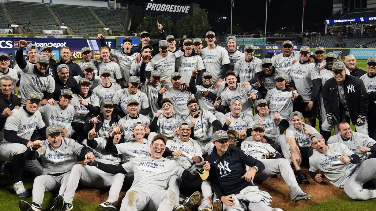 New York Yankees players pose for a team picture after Game 5 of the baseball AL Championship Series against the Cleveland Guardians Saturday, Oct. 19, 2024, in Cleveland. The Yankees won 5-2 to advance to the World Series.