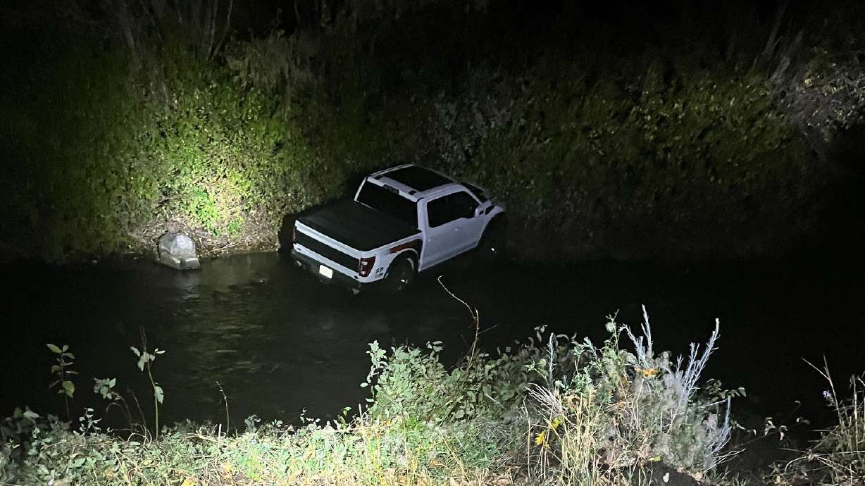 A Heber City woman was arrested Saturday and accused of stealing a truck from some college students at gunpoint near Bridal Veil Falls, then driving it into the river.
