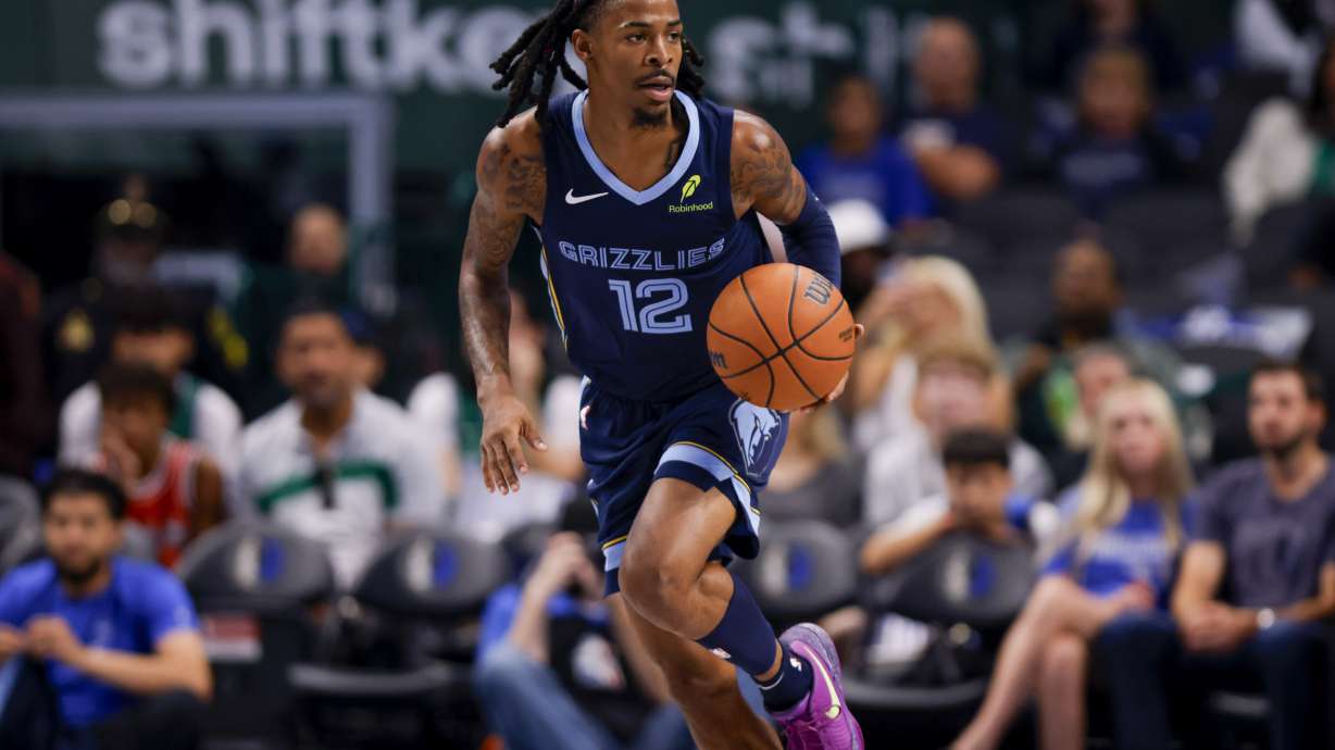 Memphis Grizzlies guard Ja Morant brings the ball down court during the first half of an NBA preseason basketball game against the Dallas Mavericks in Dallas, Monday, Oct. 7, 2024.