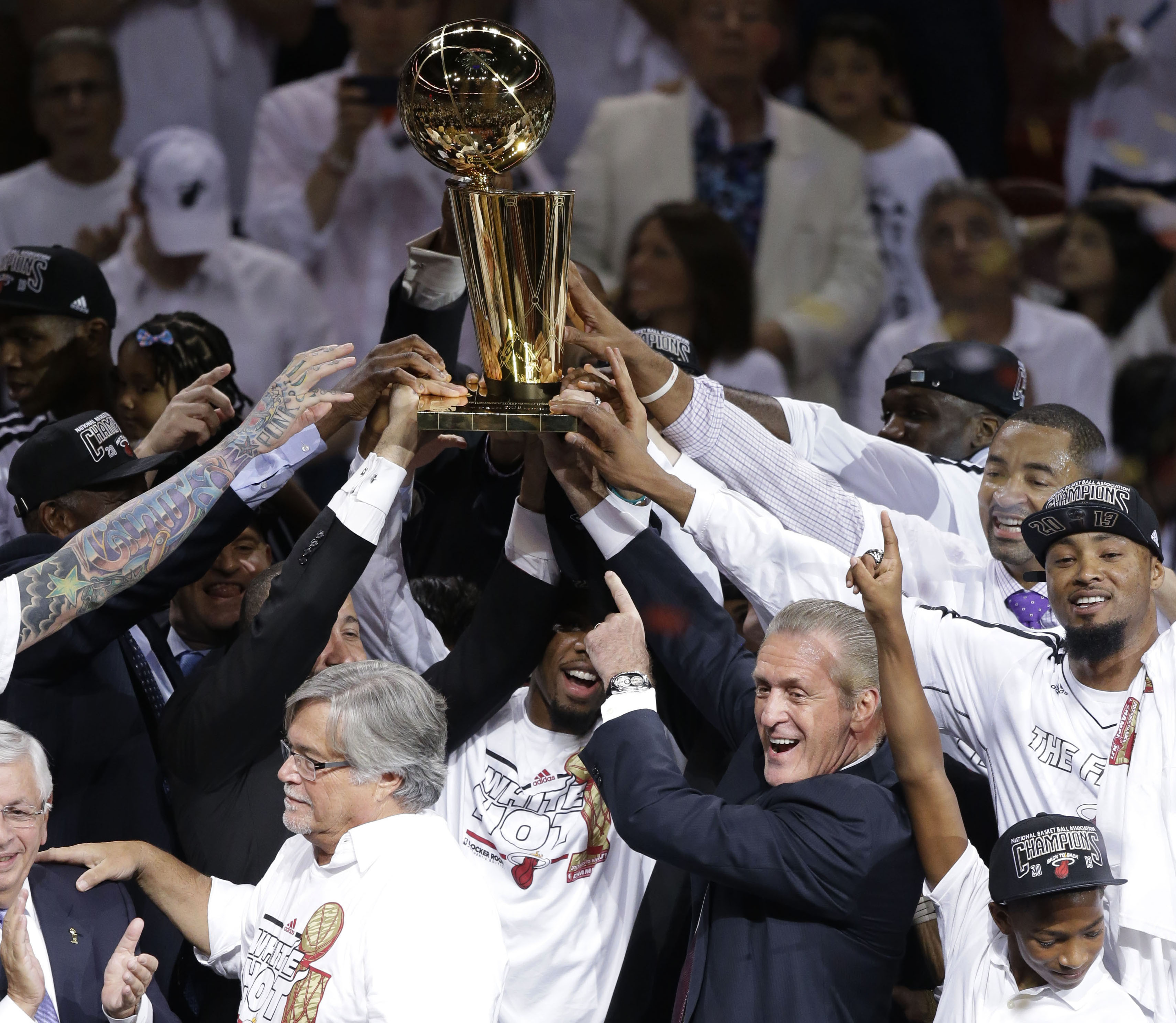 FILE - Miami Heat president Pat Riley points at the Larry O'Brien NBA Trophy after winning Game 7 of the NBA basketball championships, June 21, 2013, in Miami. 