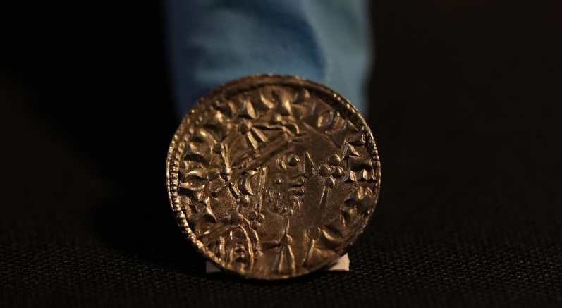 A coin, part of the Chew Valley Hoard of 2,584 coins, buried in the turmoil following the Norman Invasion of Britain in 1066, is on display at the British Museum in London, Tuesday. The hoard is valued at $5.58 million, a record find. 