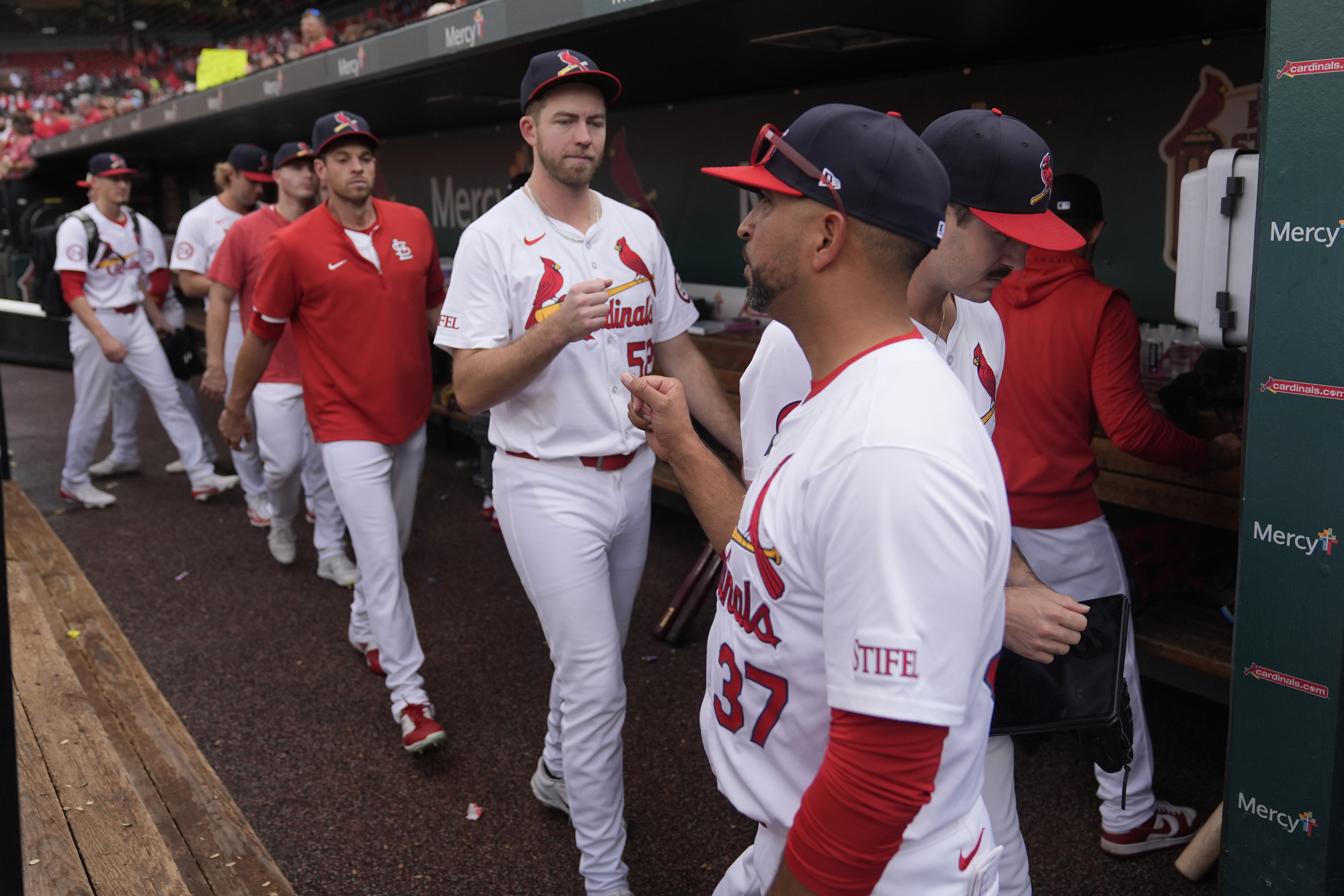 St. Louis Cardinals manager Oliver Marmol (37) fist bumps relief pitcher Matthew Liberatore as they head for the clubhouse following a baseball game against the Cleveland Guardians, the Cardinals final home game of the season, Sunday, Sept. 22, 2024, in St. Louis.