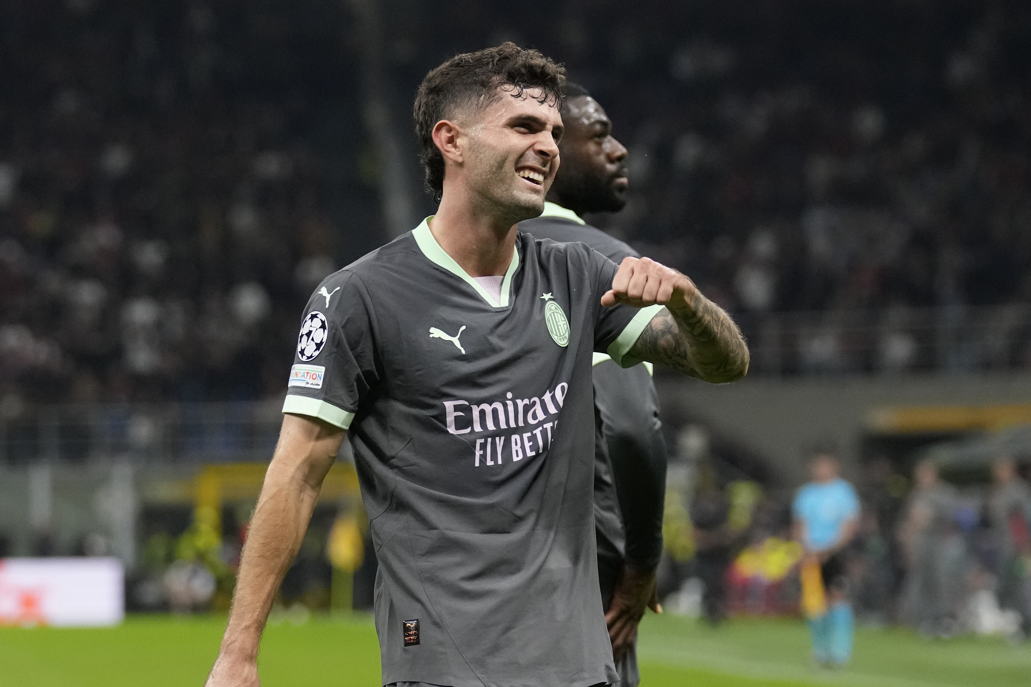 AC Milan's Christian Pulisic reacts after scoring the opening goal of his team during the Champions League opening phase soccer match between AC Milan and Club Brugge at the San Siro stadium in Milan, Italy, Tuesday, Oct. 22, 2024. 