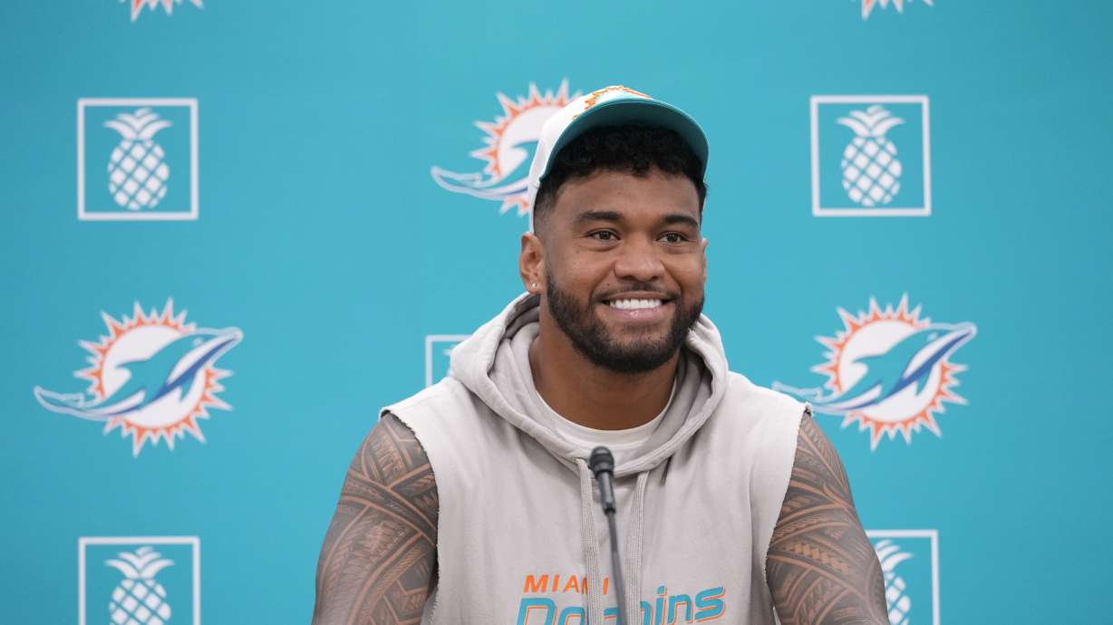 Miami Dolphins quarterback Tua Tagovailoa smiles as he takes questions during a news conference, Monday, Oct. 21, 2024, at the Dolphins training facility in Miami Gardens, Fla.