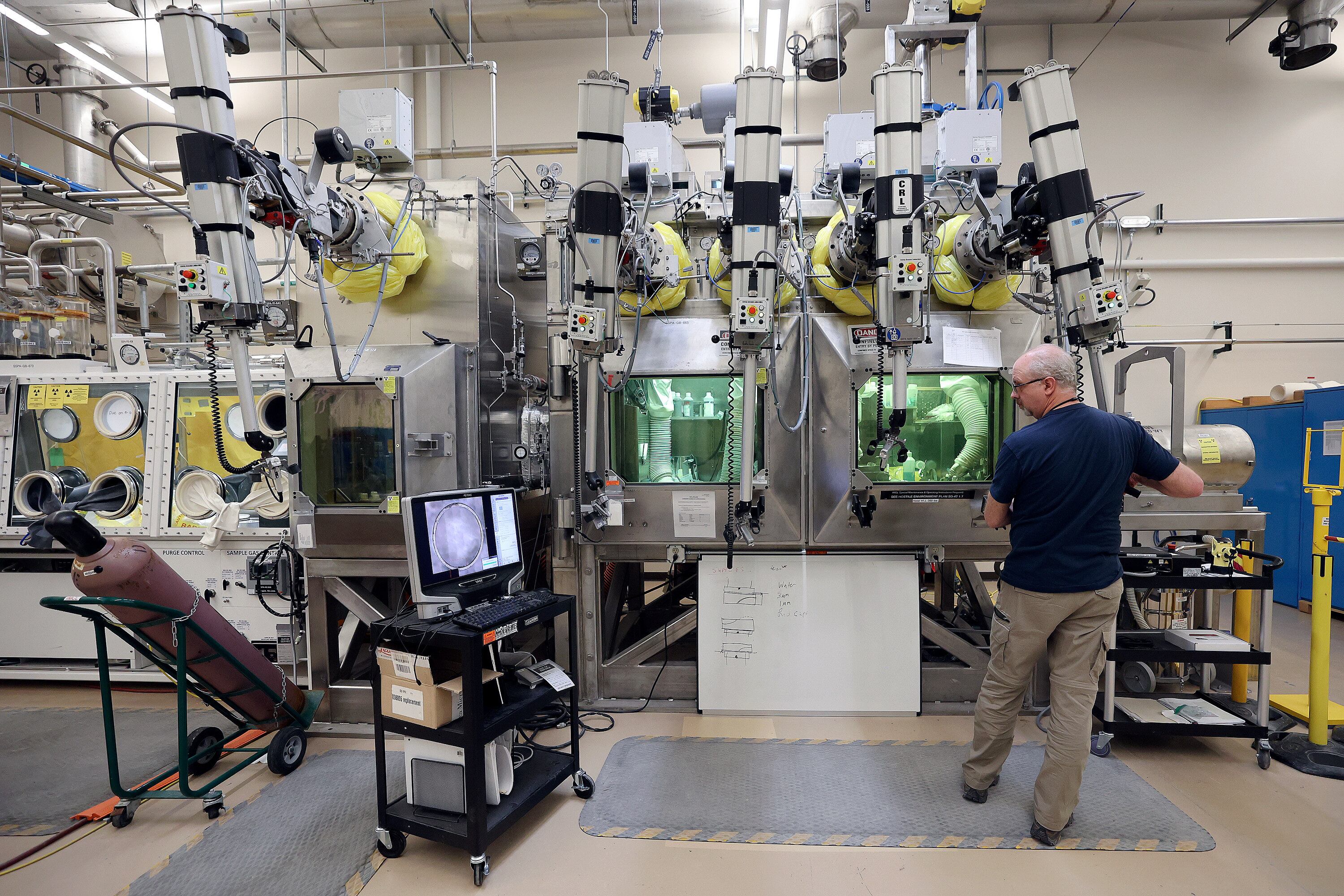 Scott Anderson prepares samples in the Materials and Fuels Complex at the Idaho National Laboratory in a remote area west of Idaho Falls on April 5, 2023. An initiative seeks to combine the efforts of eight states for advancing nuclear energy plans. 