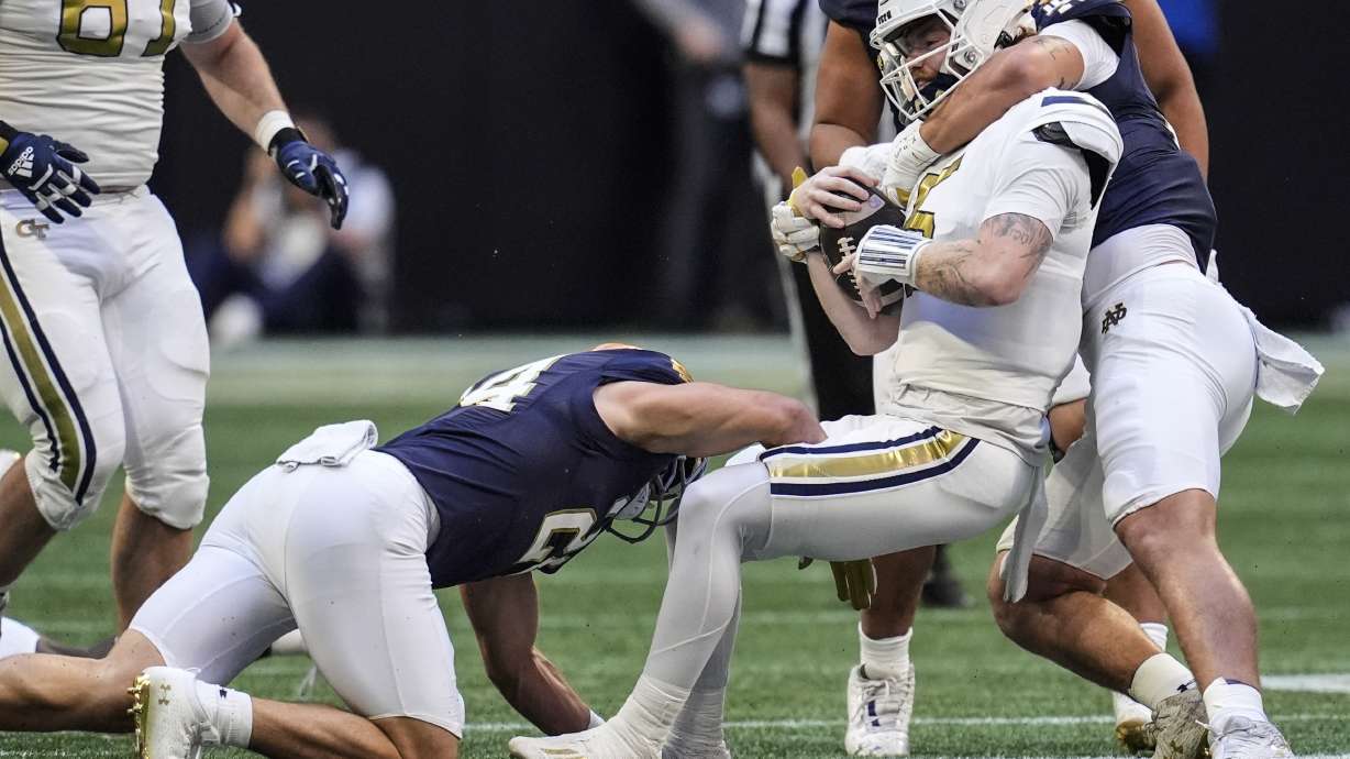 Georgia Tech quarterback Zach Pyron (5) is hit by against Notre Dames during the first half of an NCAA college football game, Saturday, Oct. 19, 2024, in Atlanta.