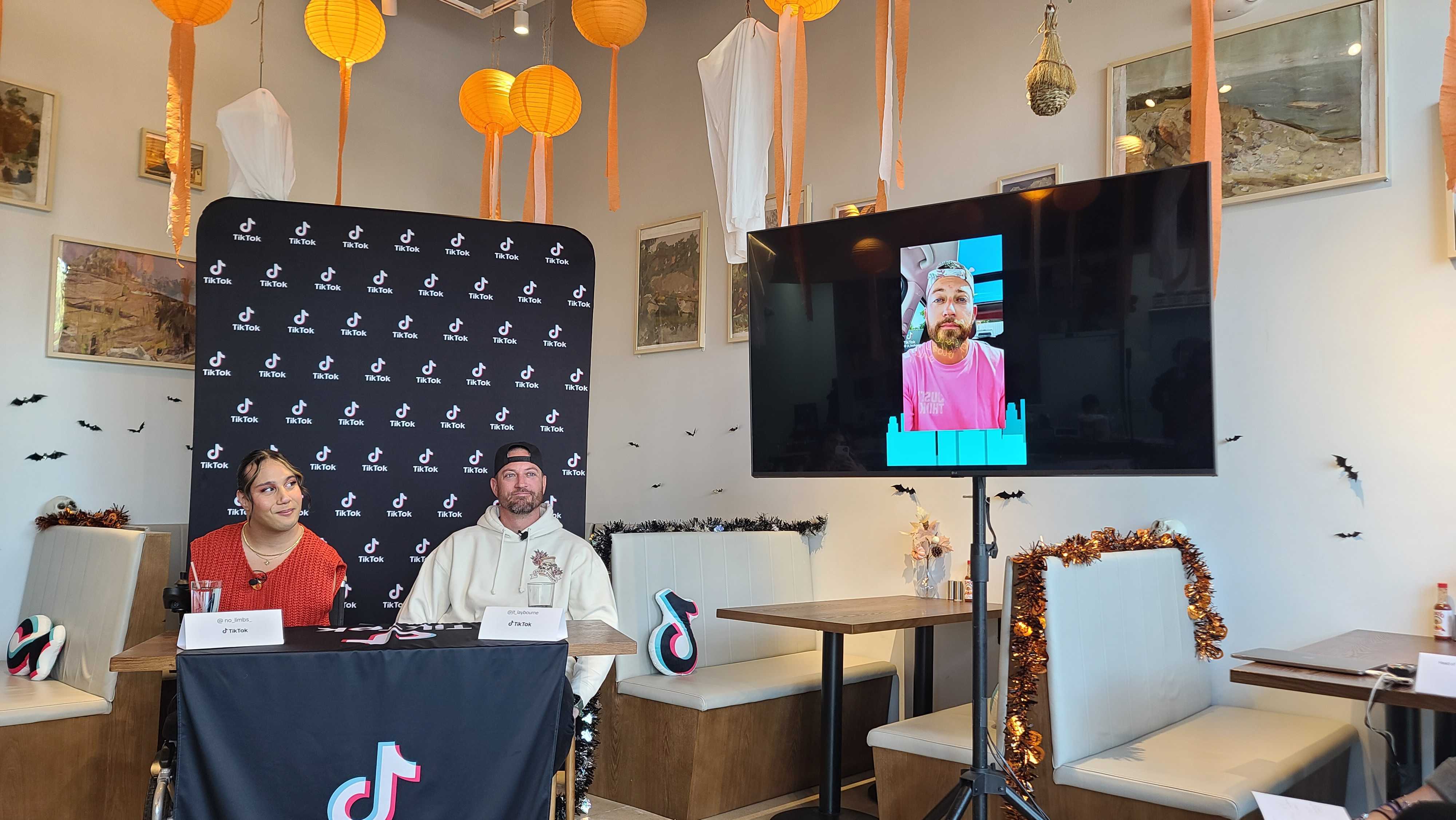 Online content creators Briel Adams-Wheatley, left, and JT Laybourne watch one of Laybourne's short-form videos at a media event hosted by TikTok at MillCrepes Cafe & Catering in Salt Lake City on Tuesday.