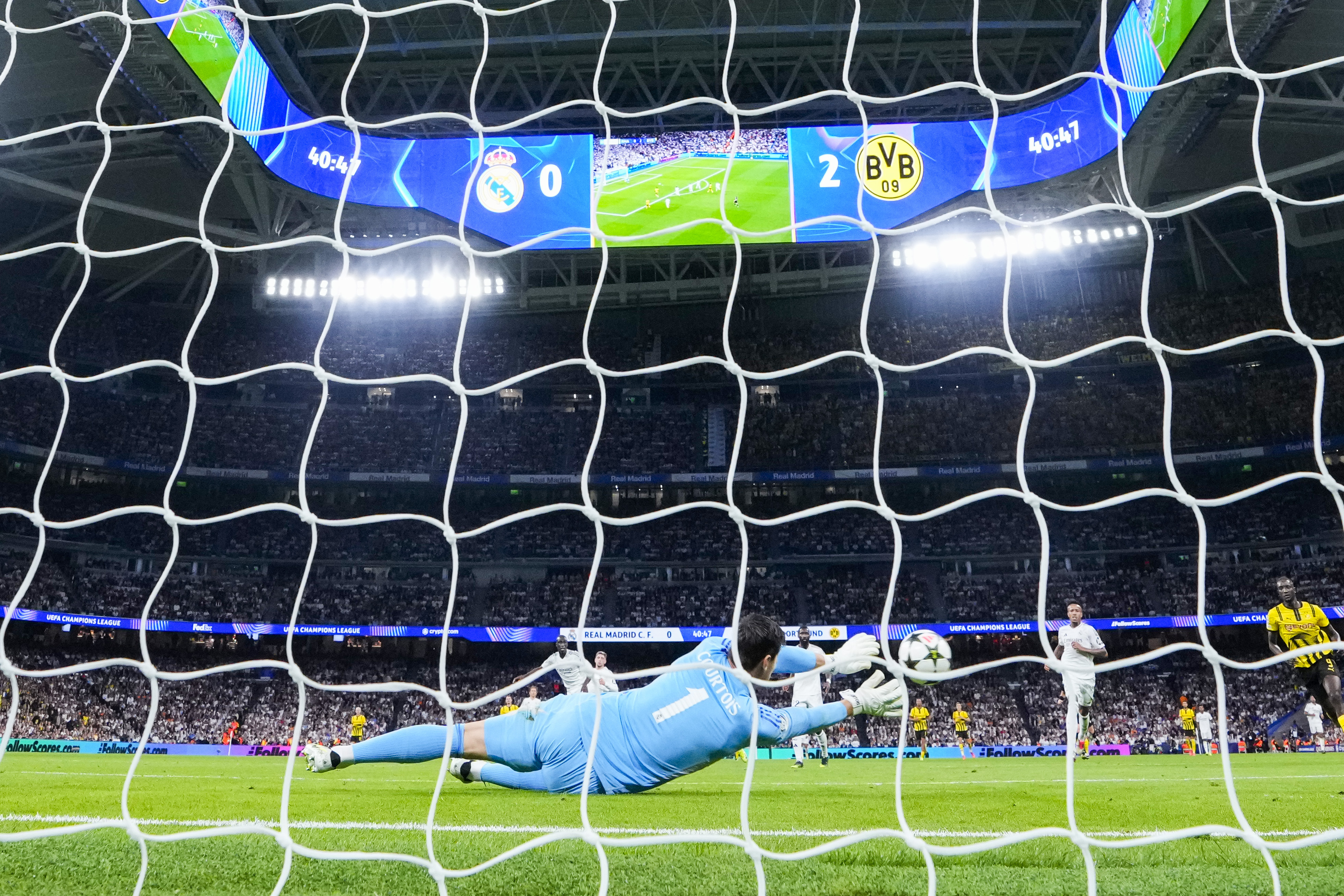 Real Madrid's goalkeeper Thibaut Courtois blocks a shoot during the Champions League opening phase soccer match between Real Madrid and Borussia Dortmund at the Santiago Bernabeu stadium in Madrid, Tuesday, Oct. 22, 2024. 
