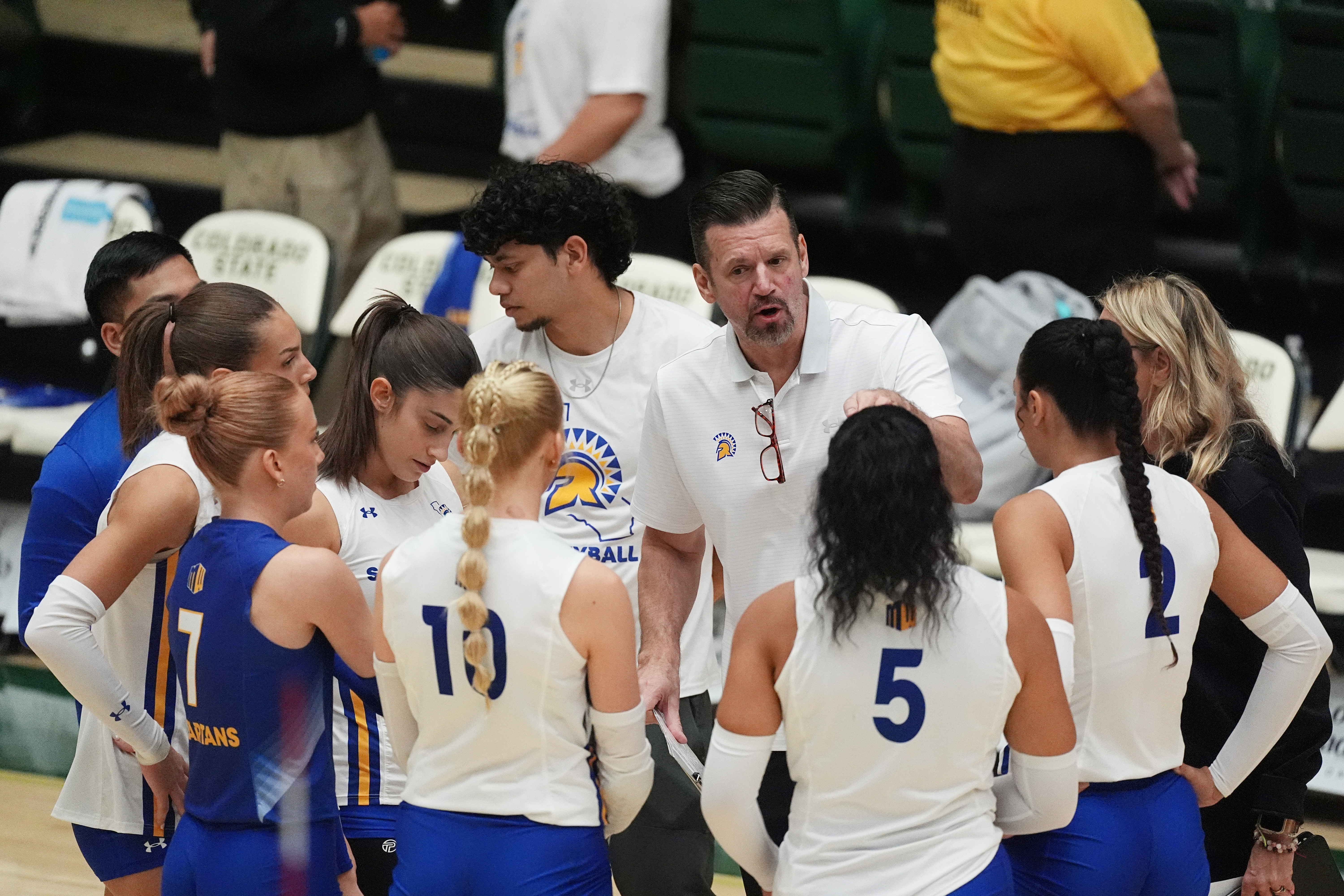 San Jose State head coach Todd Kress, center back, talks to his players during a timeout during the first set of an NCAA college volleyball match against Colorado State, Thursday, Oct. 3, 2024, in Fort Collins, Colo.