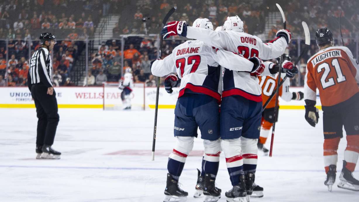 Washington Capitals' Nic Dowd, center, celebrates his goal with teammates during the first period of an NHL hockey game against the Philadelphia Flyers, Tuesday, Oct. 22, 2024, in Philadelphia.