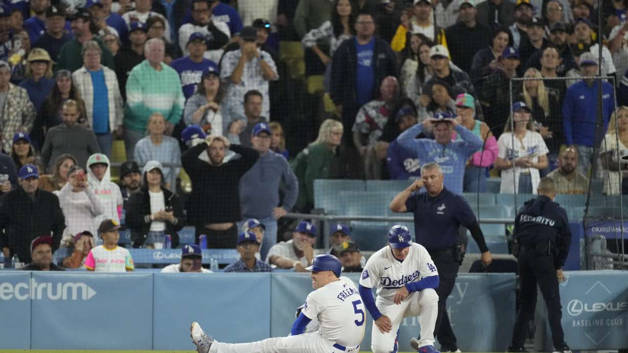 Los Angeles Dodgers' Freddie Freeman (5) suffers an injury after grounding out during the seventh inning of a baseball game against the San Diego Padres, Thursday, Sept. 26, 2024, in Los Angeles.