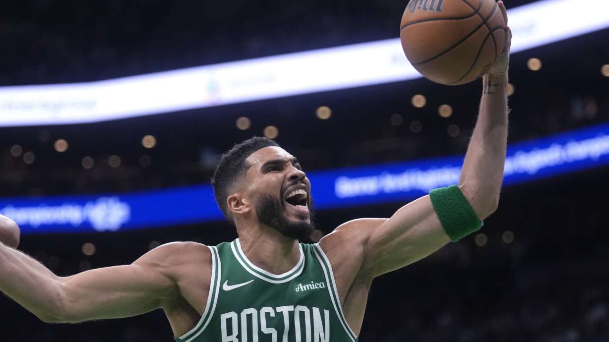 Boston Celtics forward Jayson Tatum grabs a rebound against the New York Knicks during the first half of an NBA basketball game, Tuesday, Oct. 22, 2024, in Boston.