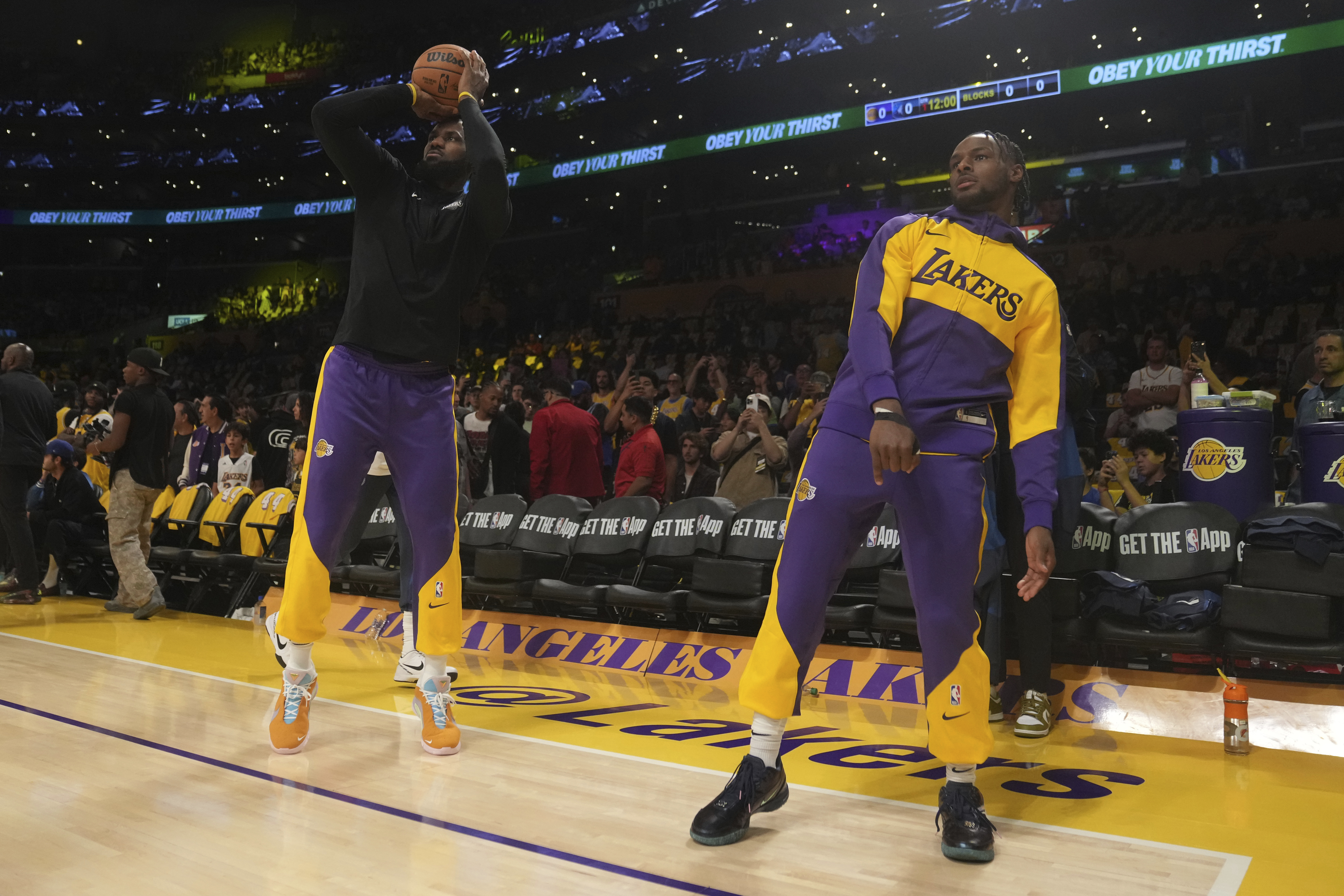 Los Angeles Lakers forward LeBron James, left, and guard Bronny James warm up before an NBA basketball game against the Minnesota Timberwolves, Tuesday, Oct. 22, 2024, in Los Angeles.