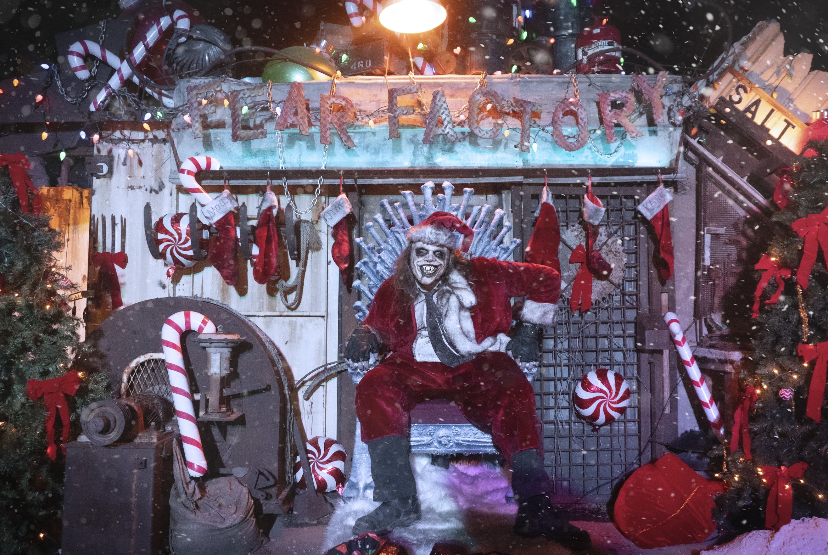 Caretaker Karl, a mascot of Fear Factory, poses for a photo in a Santa suit in the haunted house's Christmas Town section. The Salt Lake business will debut the feature over the next two weekends.