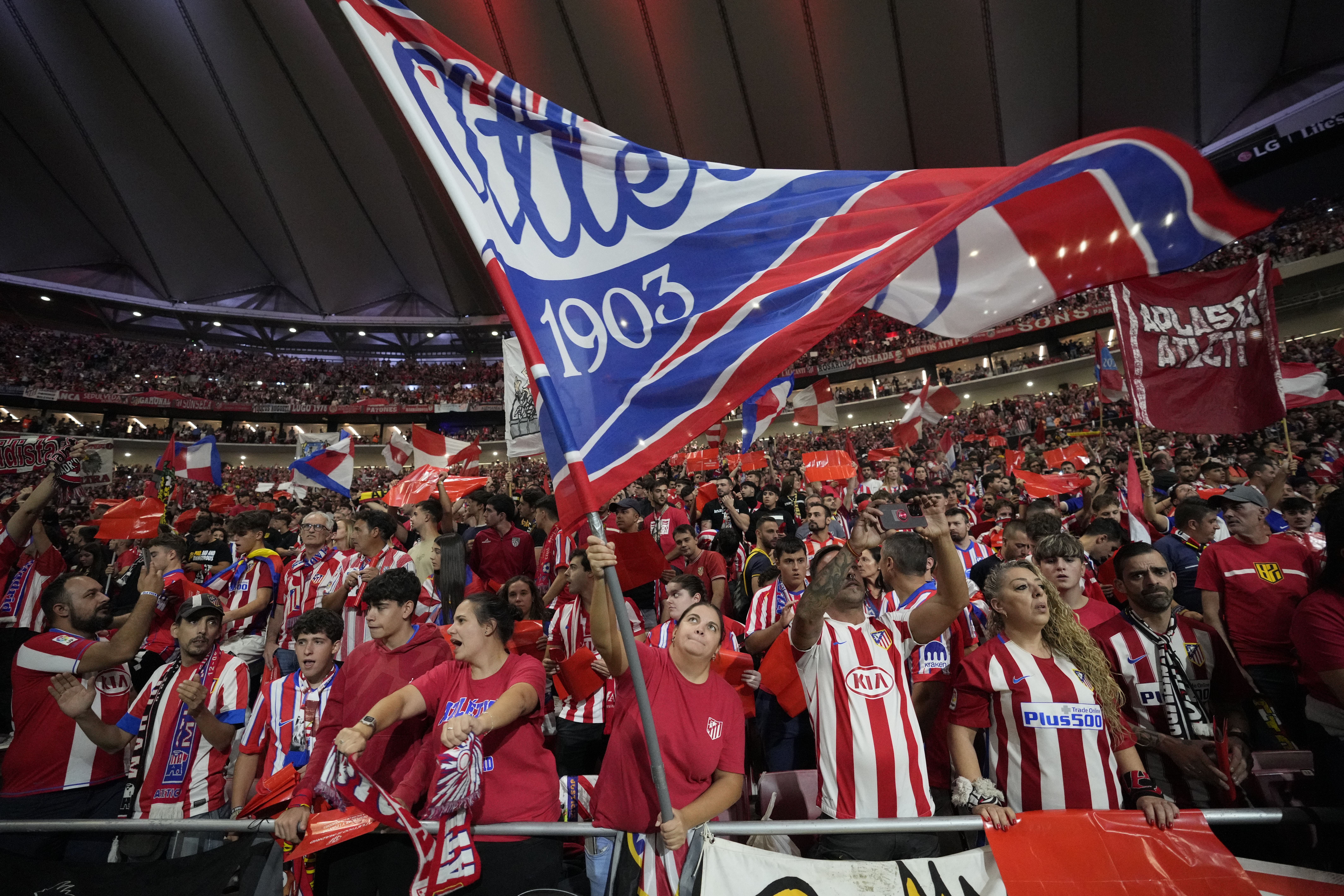 Atletico fans cheer before the La Liga soccer match between Atletico Madrid and Real Madrid at the Metropolitano stadium in Madrid, Spain, Sunday, Sept. 29, 2024.