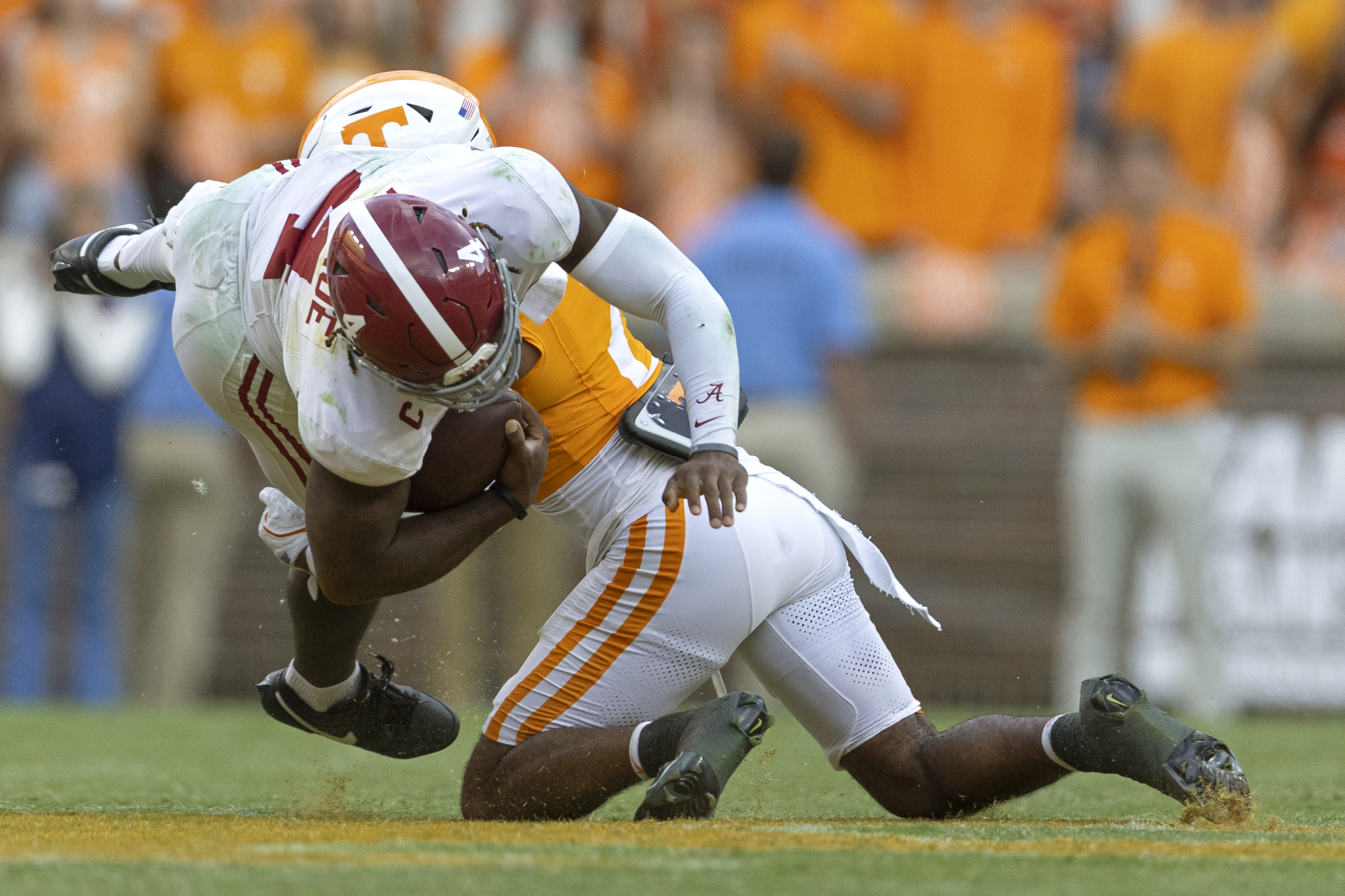 Alabama quarterback Jalen Milroe (4) is tackled by Tennessee defensive back Andre Turrentine (2) during the second half of an NCAA college football game Saturday, Oct. 19, 2024, in Knoxville, Tenn. 