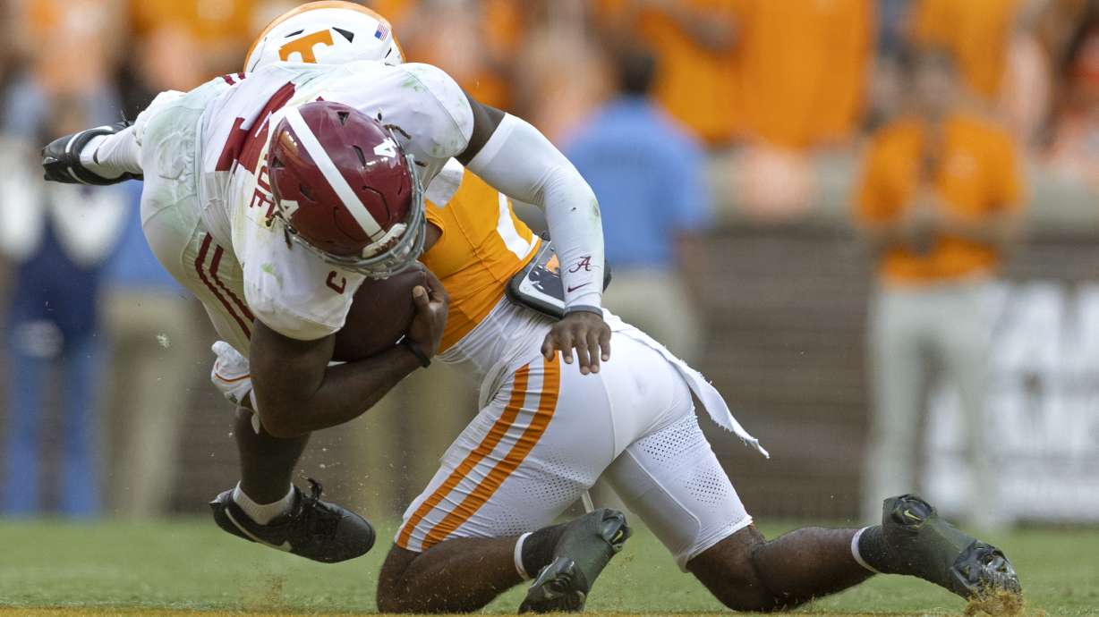 Alabama quarterback Jalen Milroe (4) is tackled by Tennessee defensive back Andre Turrentine (2) during the second half of an NCAA college football game Saturday, Oct. 19, 2024, in Knoxville, Tenn.