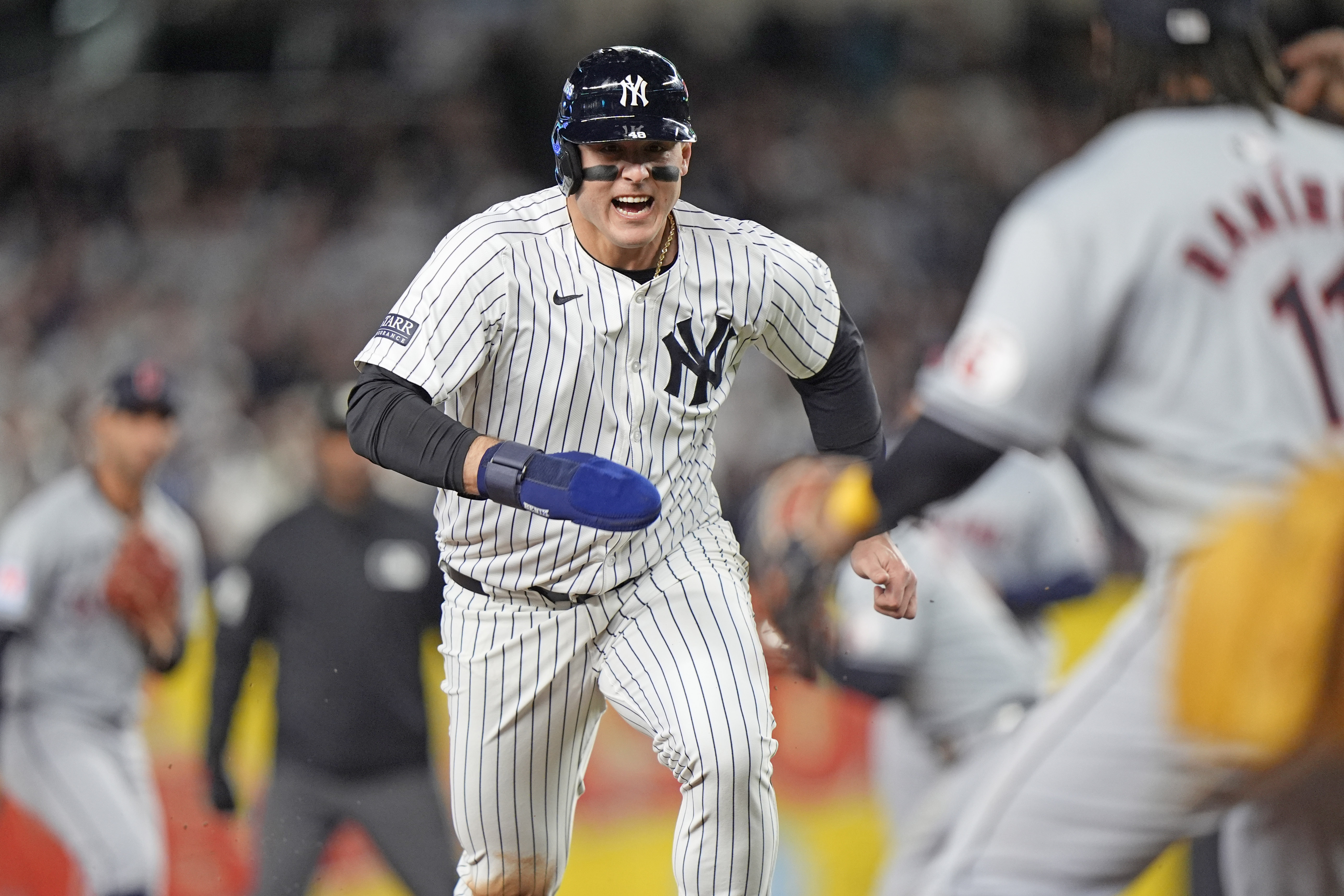 New York Yankees' Anthony Rizzo, left, runs toward third base before being tagged out by Cleveland Guardians third baseman José Ramírez (11) after being caught in a rundown during the sixth inning in Game 2 of the baseball AL Championship Series Tuesday, Oct. 15, 2024, in New York.