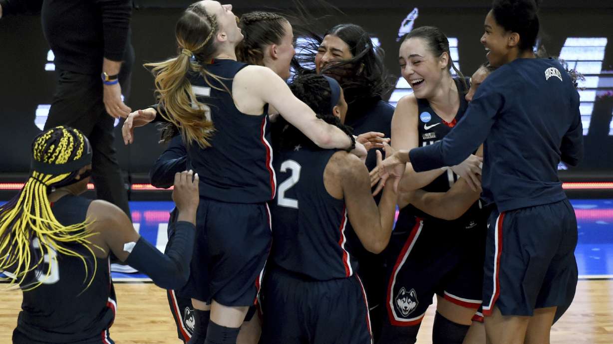 FILE - The UConn team celebrates after winning an Elite Eight college basketball game against Southern California in the women's NCAA Tournament, April 1, 2024, in Portland, Ore.