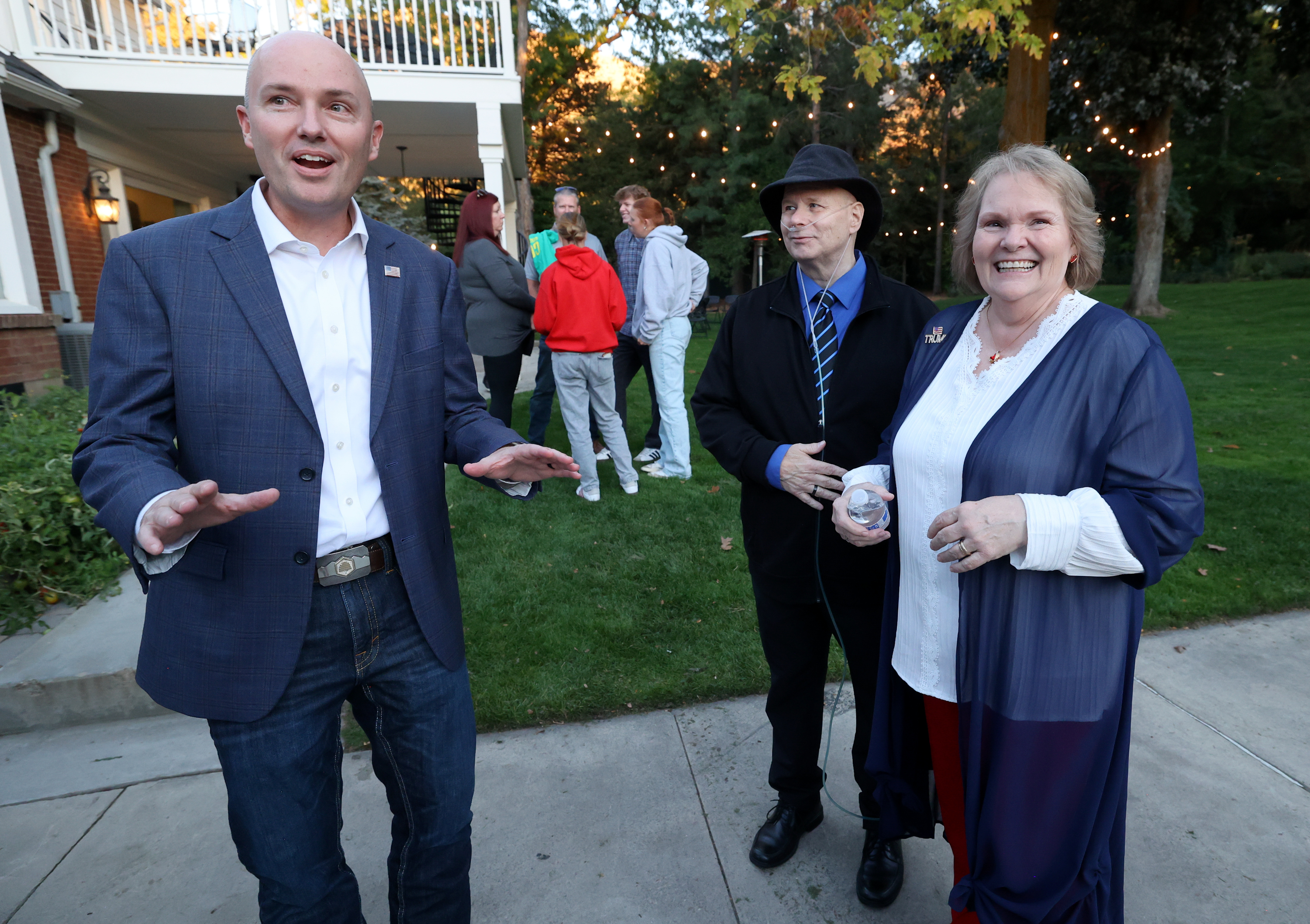 Gov. Spencer Cox talks with Marty Jensen and Lynette Jensen at a meet-and-greet in Ogden on Monday.
