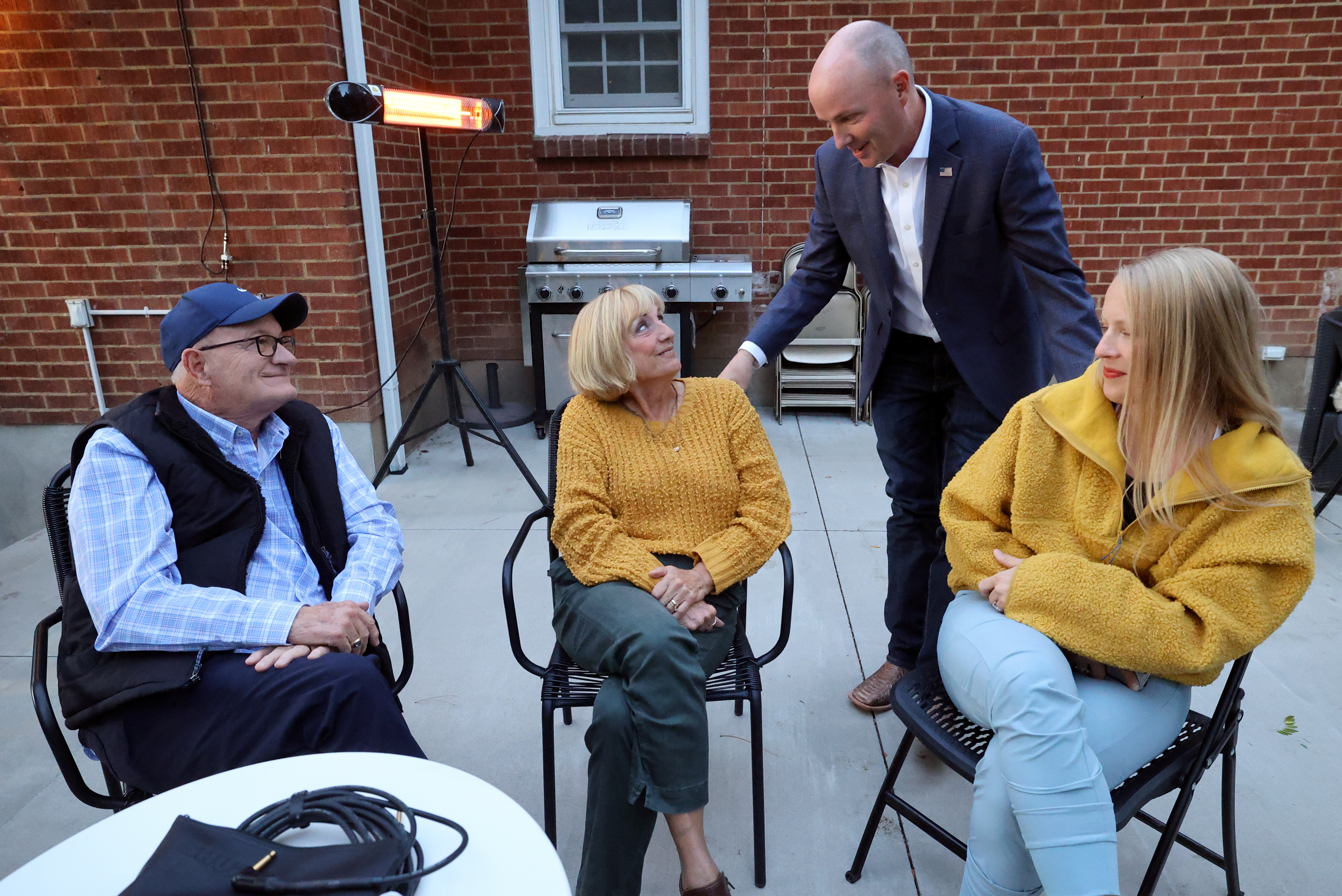 Gov. Spencer Cox talks with Dale Stephens, Sharon Stephens and Sarah Richards at a meet and greet in Ogden on Monday.