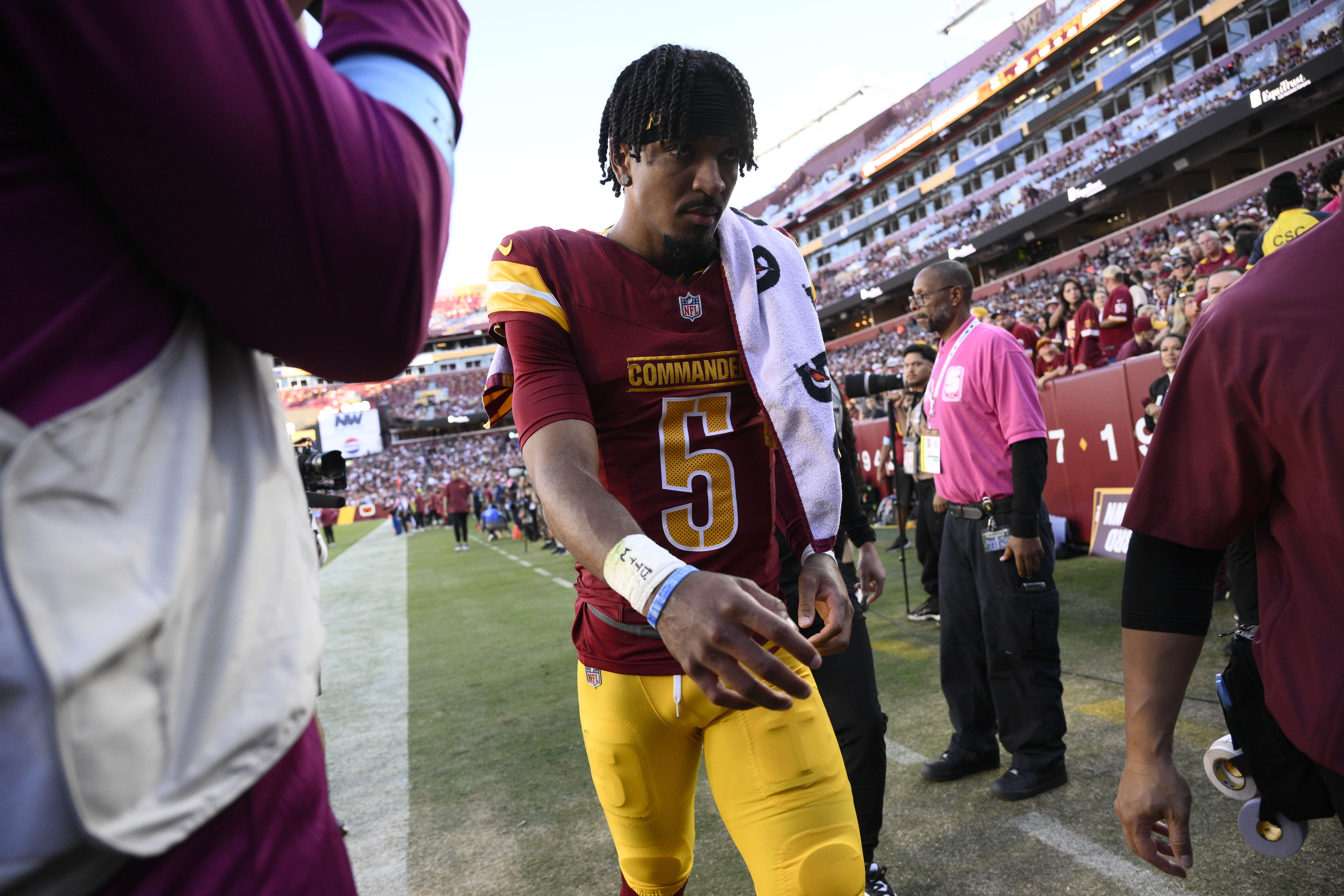 Washington Commanders quarterback Jayden Daniels walks off the field after getting injured during the first half of an NFL football game against the Carolina Panthers, Sunday, Oct. 20, 2024, in Landover, Md.