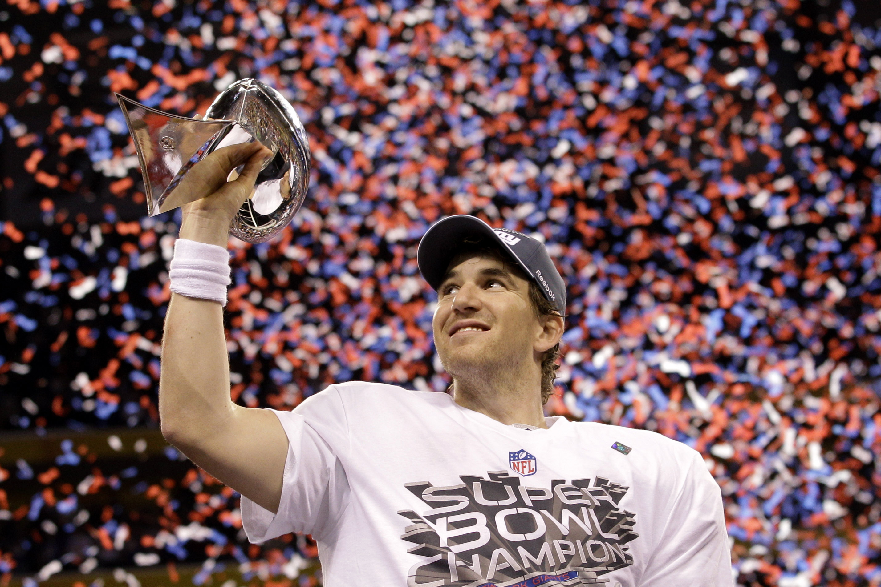 FILE - New York Giants quarterback Eli Manning holds up the Vince Lombardi Trophy while celebrating his team's 21-17 win over the New England Patriots in the NFL Super Bowl XLVI football game, Feb. 5, 2012, in Indianapolis. 