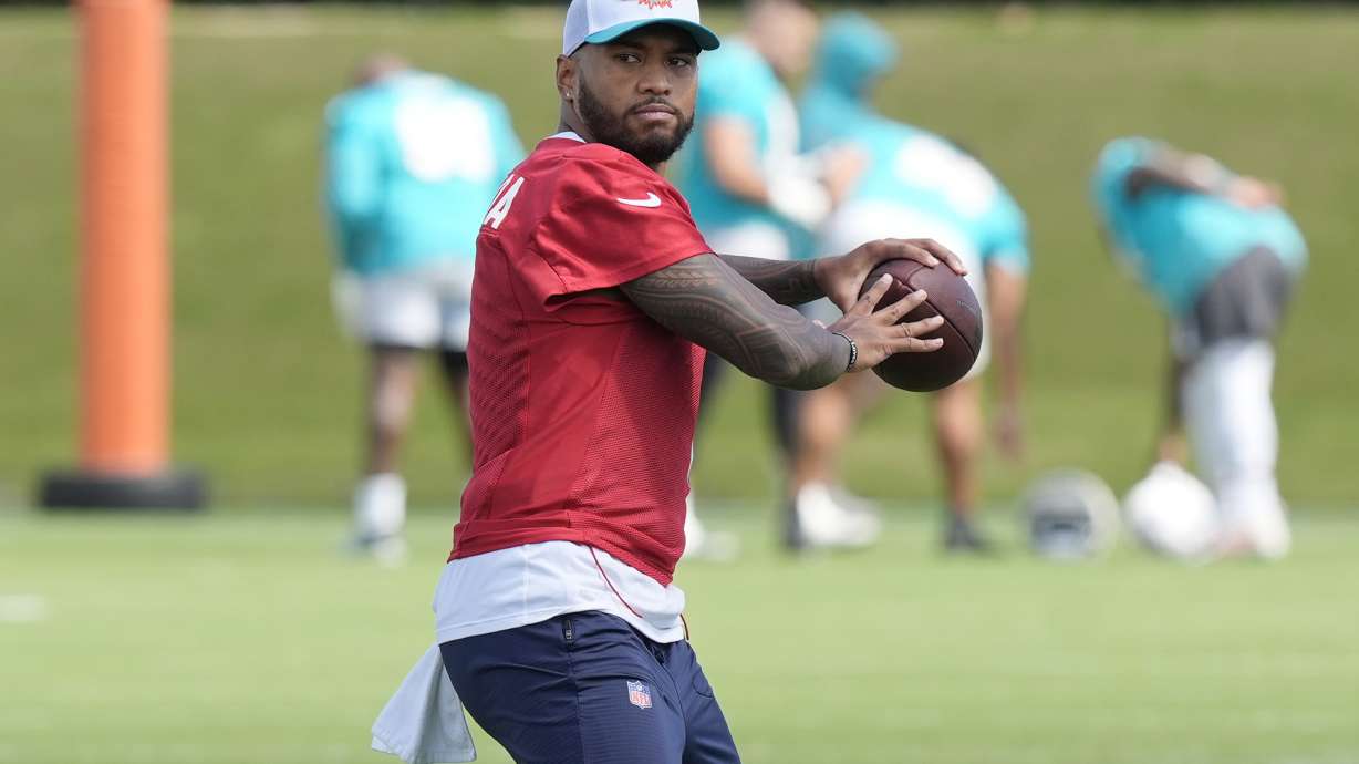 Miami Dolphins quarterback Tua Tagovailoa (1) aims the ball during a practice session at the team's training facility, Wednesday, Oct. 23, 2024, in Miami Gardens, Fla.